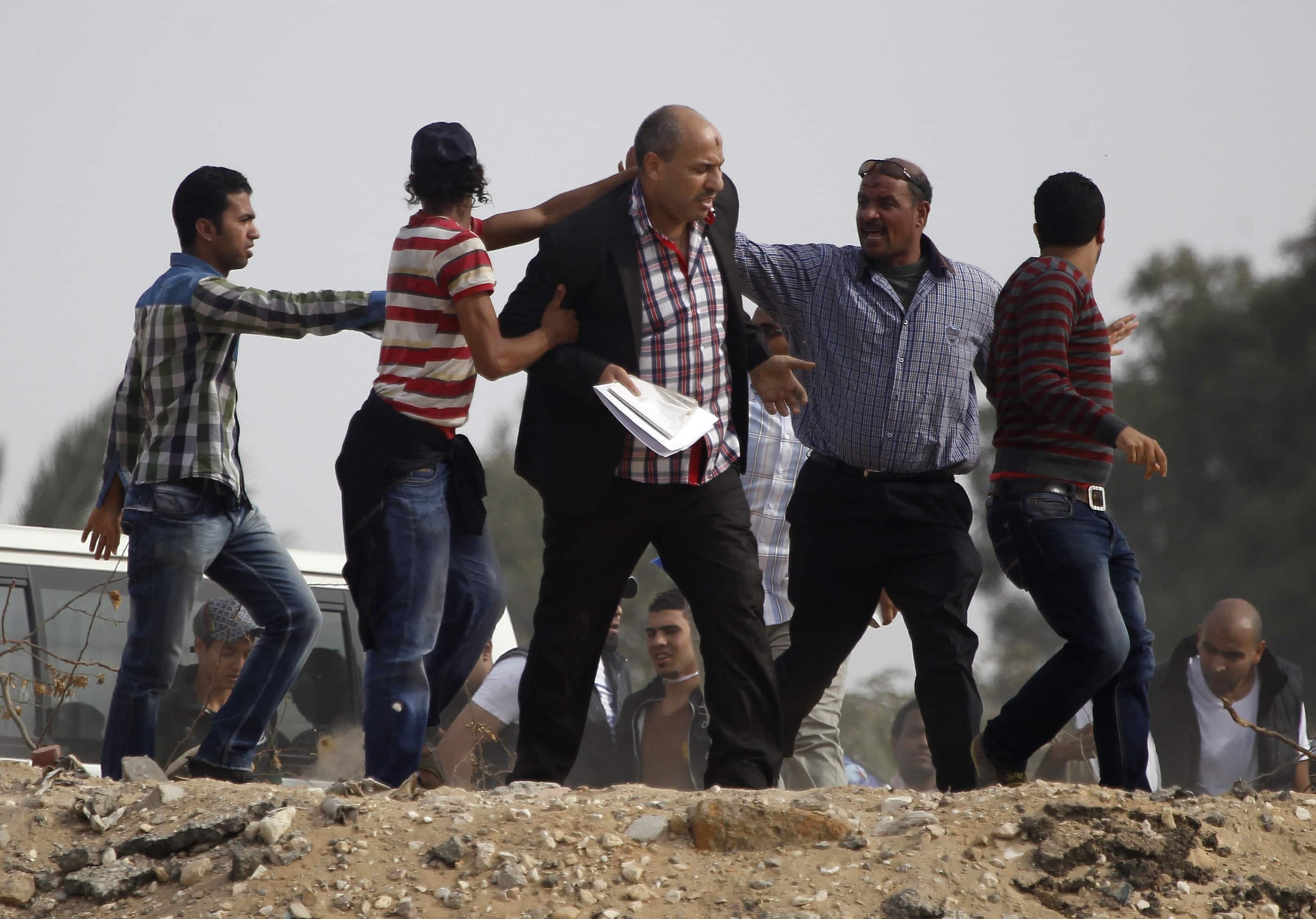 Supporters of the Muslim Brotherhood try to push a journalist, center, away from the police academy where ousted President Mohamed Morsi was on trial on the outskirts of Cairo, November 4, 2013. Perhaps nowhere did press freedom decline more dramatically in 2013 than in polarised Egypt, REUTERS/Amr Abdallah Dalsh