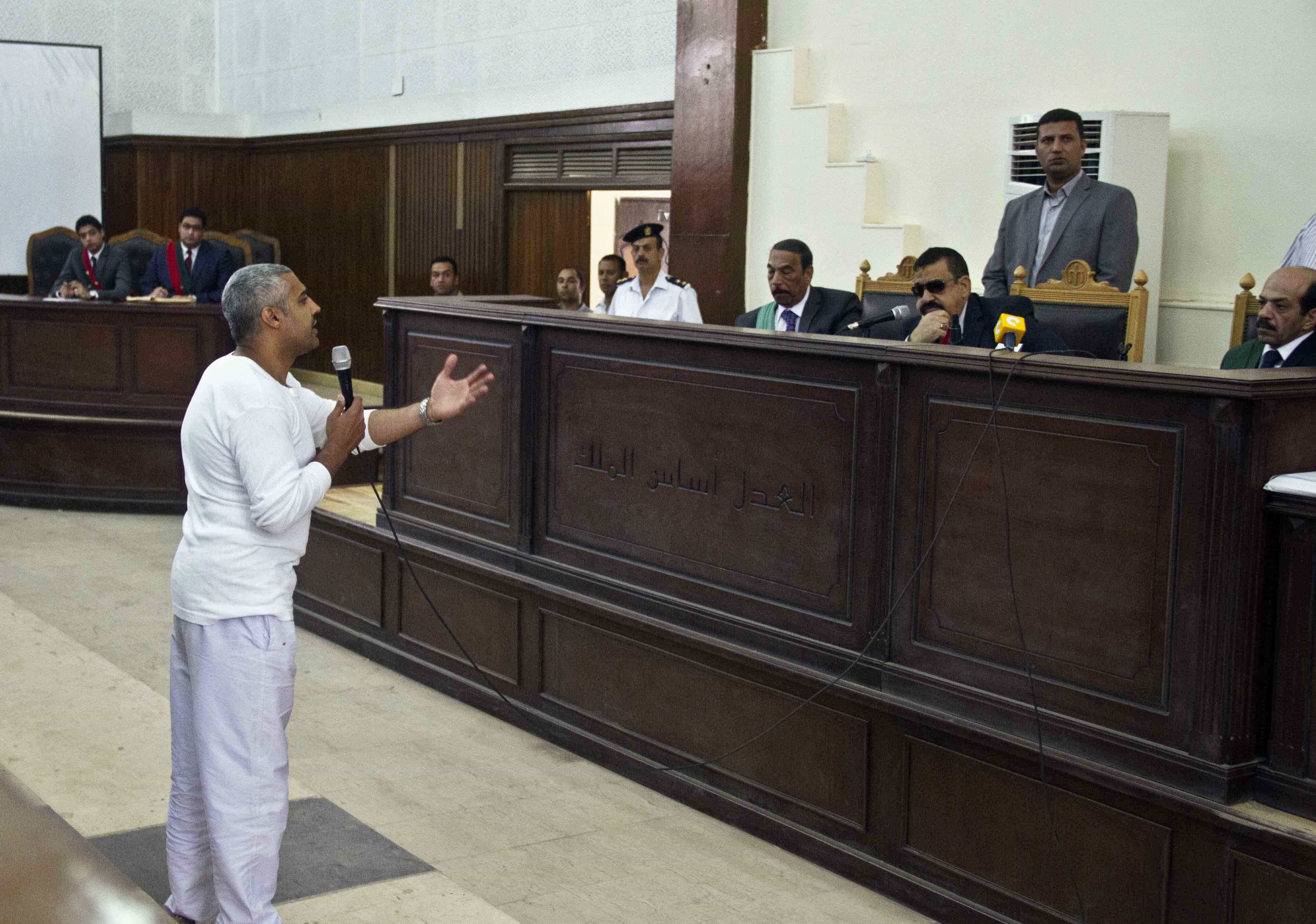 In this 3 May 2014 file photo, Canadian-Egyptian Al-Jazeera journalist Mohammed Fahmy talks to a judge in court along with several other defendants during their trial on terror charges in Egypt, AP Photo/Hamada Elrasam, File