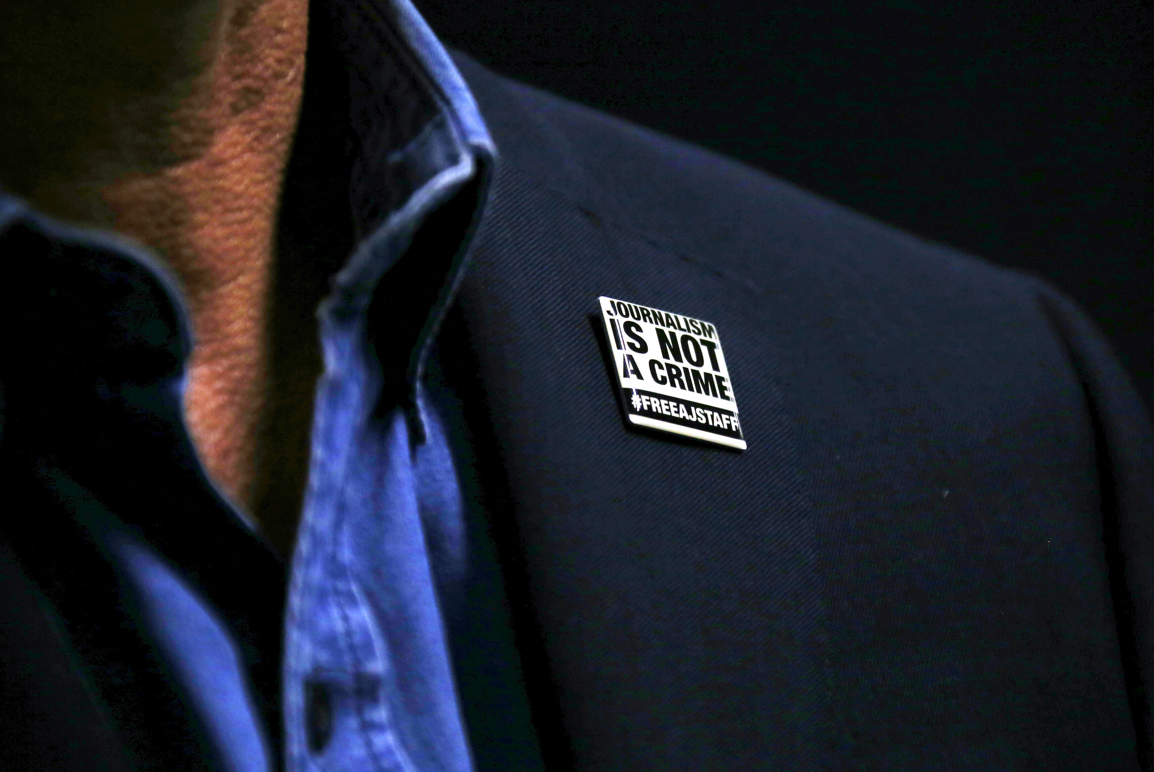 A badge hangs from the jacket of Al Jazeera reporter Peter Greste of Australia as he talks during an interview with Reuters in Sydney, Australia, 29 May 2015, REUTERS/David Gray