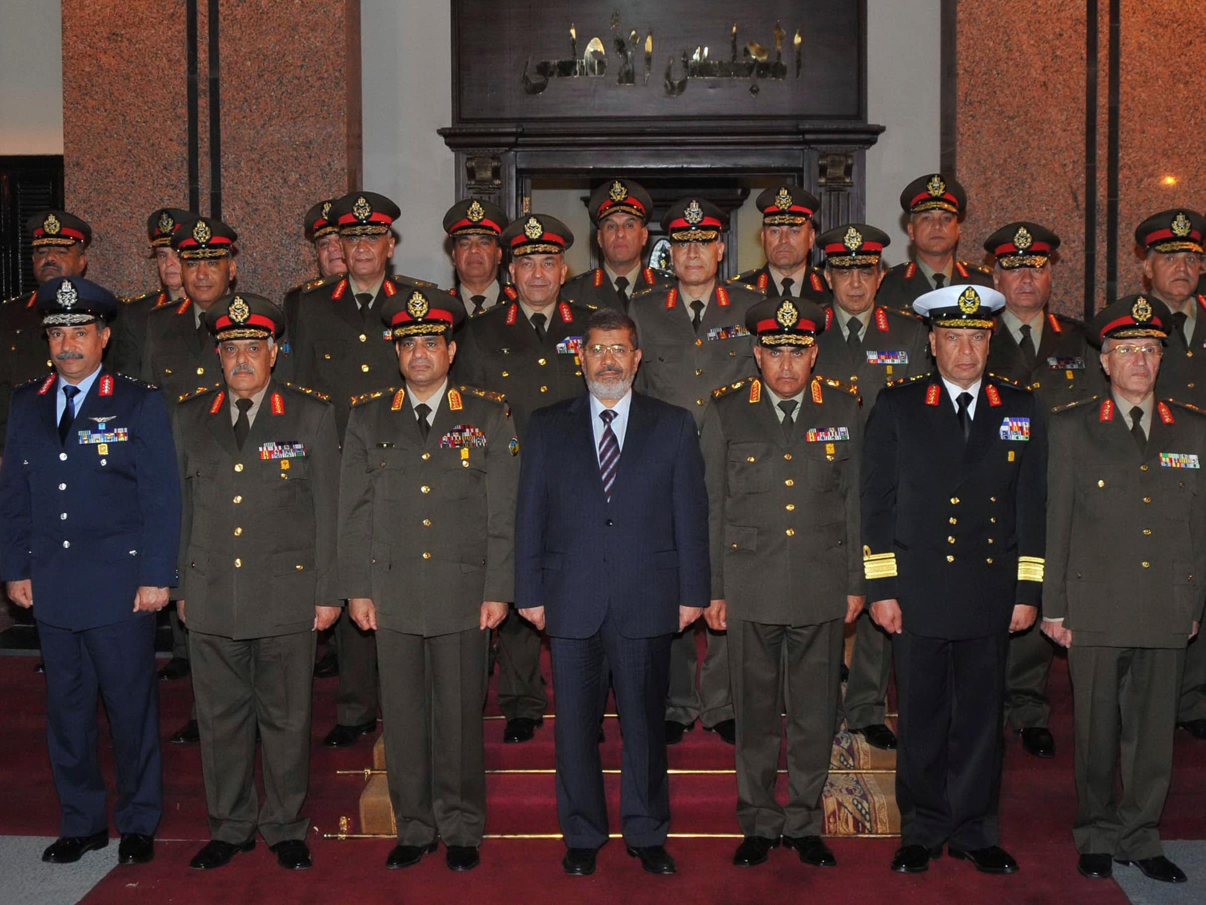 Egypt's President Mohamed Mursi (bottom row, C) and Defence Minister General Abdel Fattah Sisi (bottom row, 3rd L) pose with other military officers after a meeting with the Supreme Council of the Armed Forces in Cairo on 11 April 2013, REUTERS/Egyptian Presidency/Handout