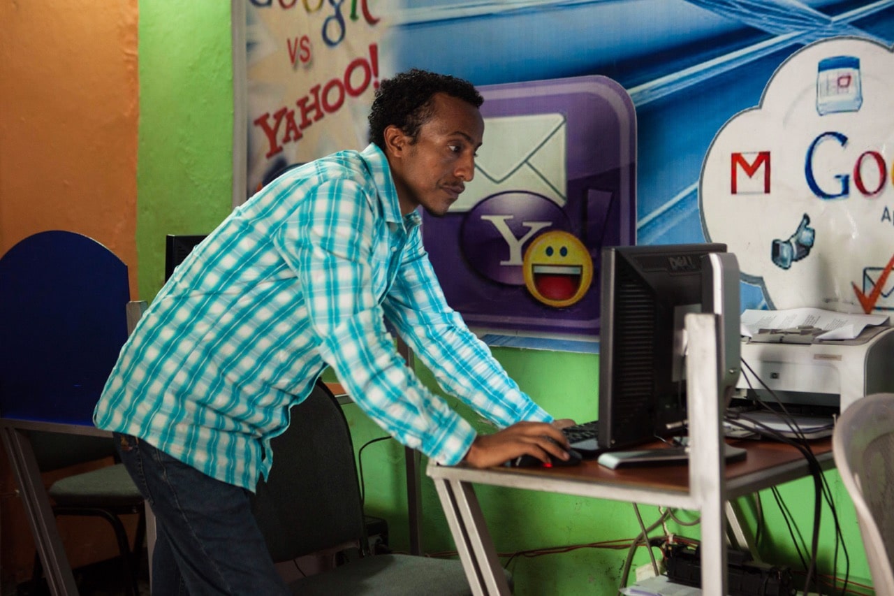 The owner of an internet cafe checks a computer, in the city of Adama, Ethiopia, 4 April 2018, SOLAN KOLLI/AFP/Getty Images