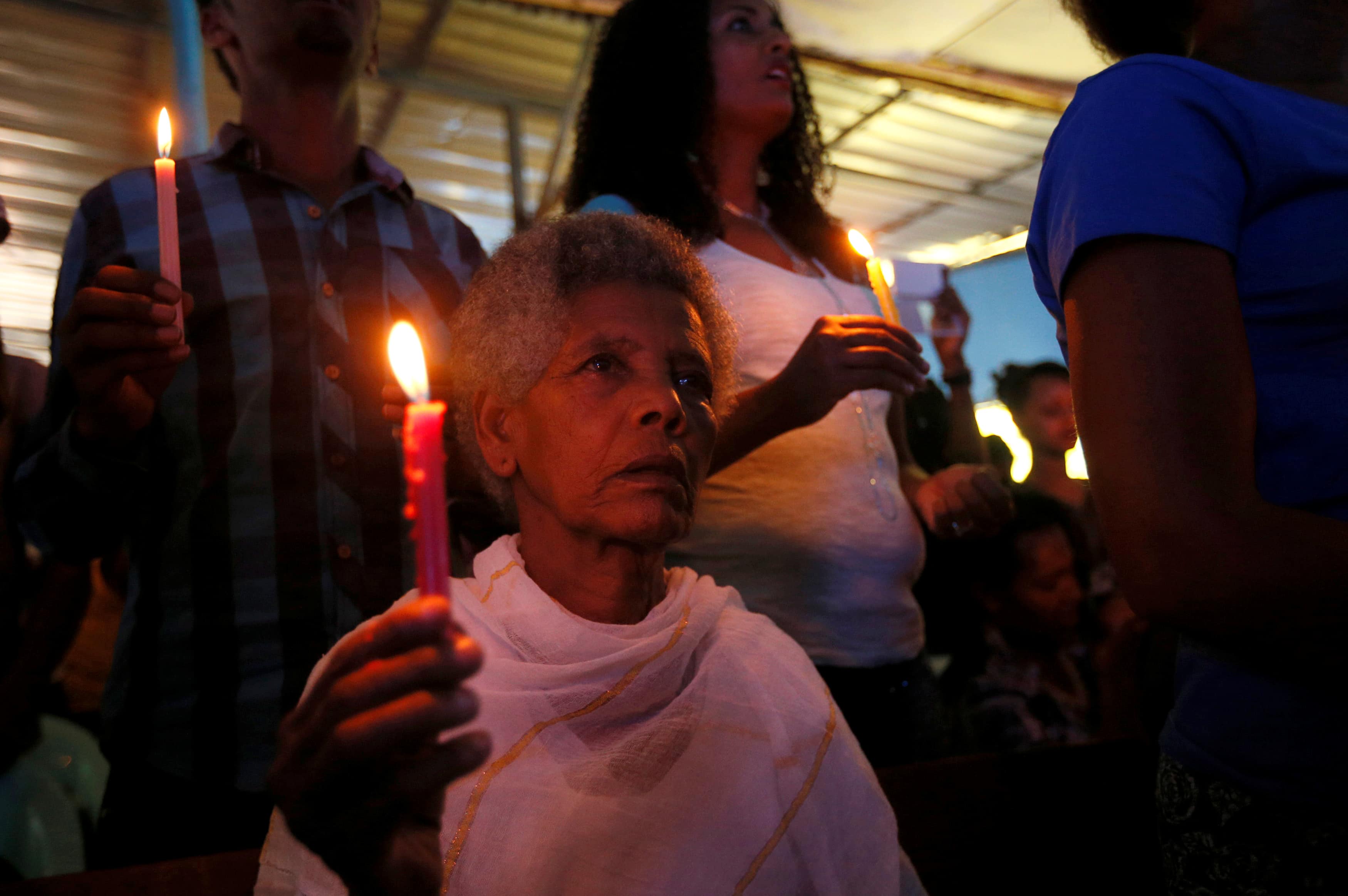 A woman attends a prayer session at Biftu Bole Lutheran Church during a prayer and candle ceremony for protesters who died in the town of Bishoftu a week ago during Ireecha, the thanksgiving festival for the Oromo people, Addis Ababa, Ethiopia, 9 October 2016, REUTERS/Tiksa Negeri