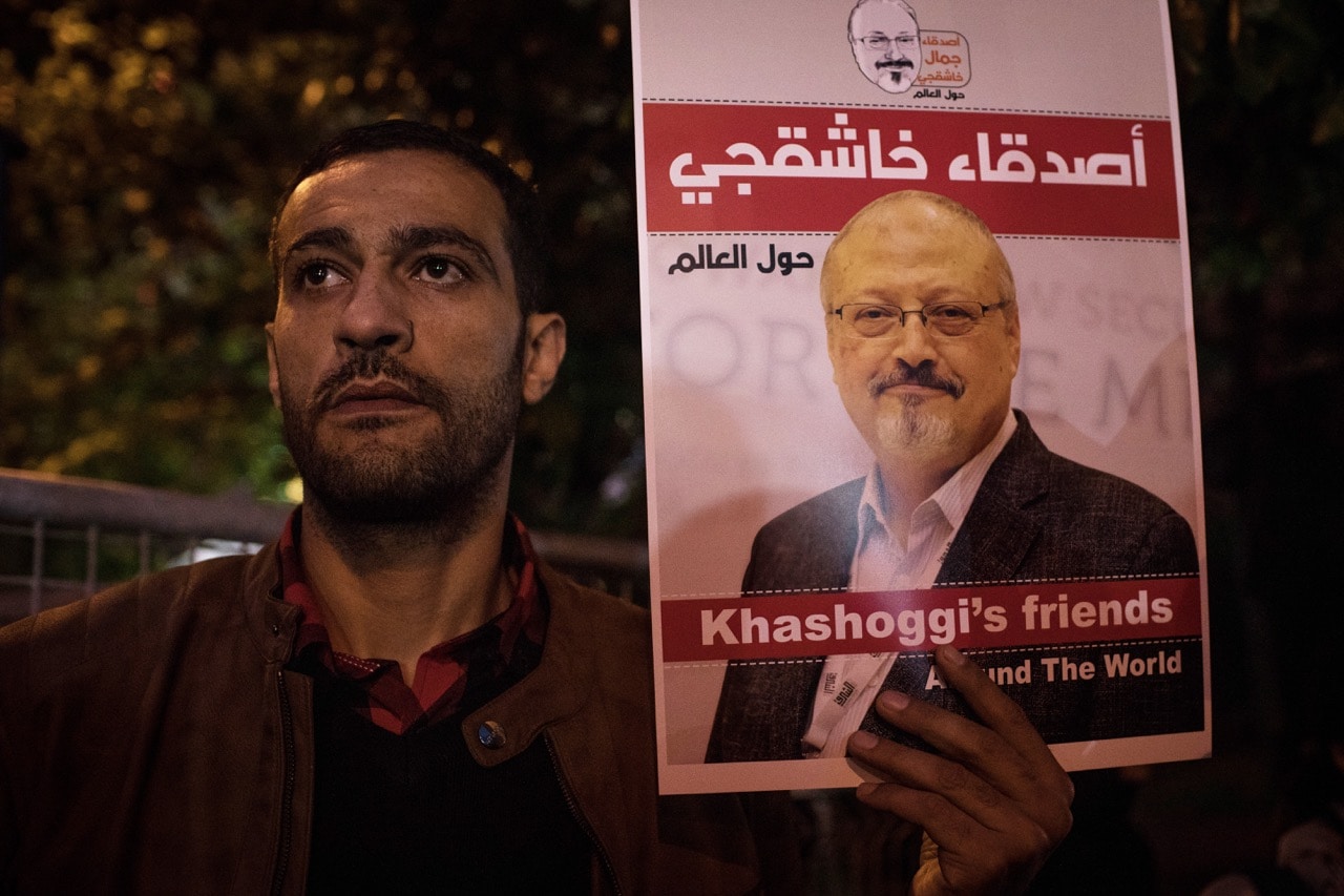 A man holds a poster of journalist Jamal Khashoggi during a vigil outside the Saudi Arabia consulate in Istanbul, Turkey, 25 October 2018, Chris McGrath/Getty Images