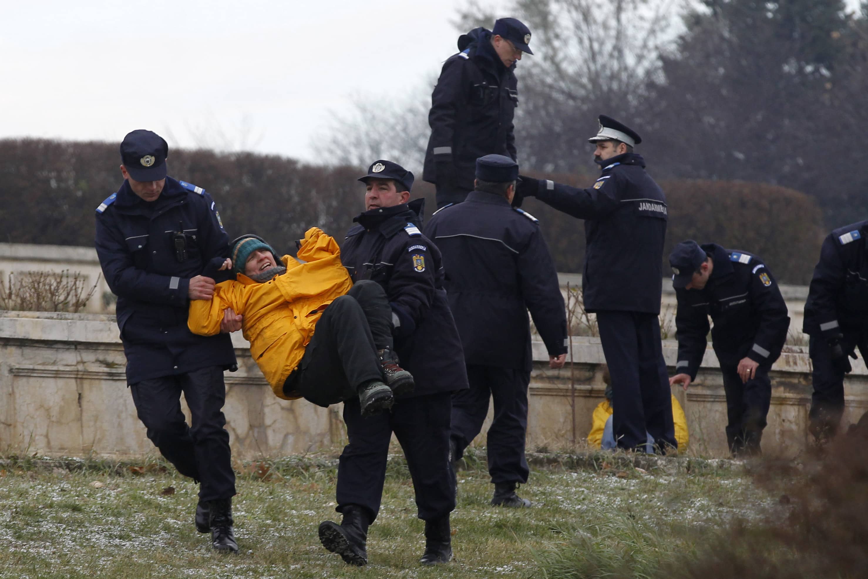 A Greenpeace activist is detained by gendarmes, after the group protested against a Canadian company's plan to set up Europe's biggest open-cast gold mine in Romania, Bucharest, 9 December 2013, REUTERS/Bogdan Cristel