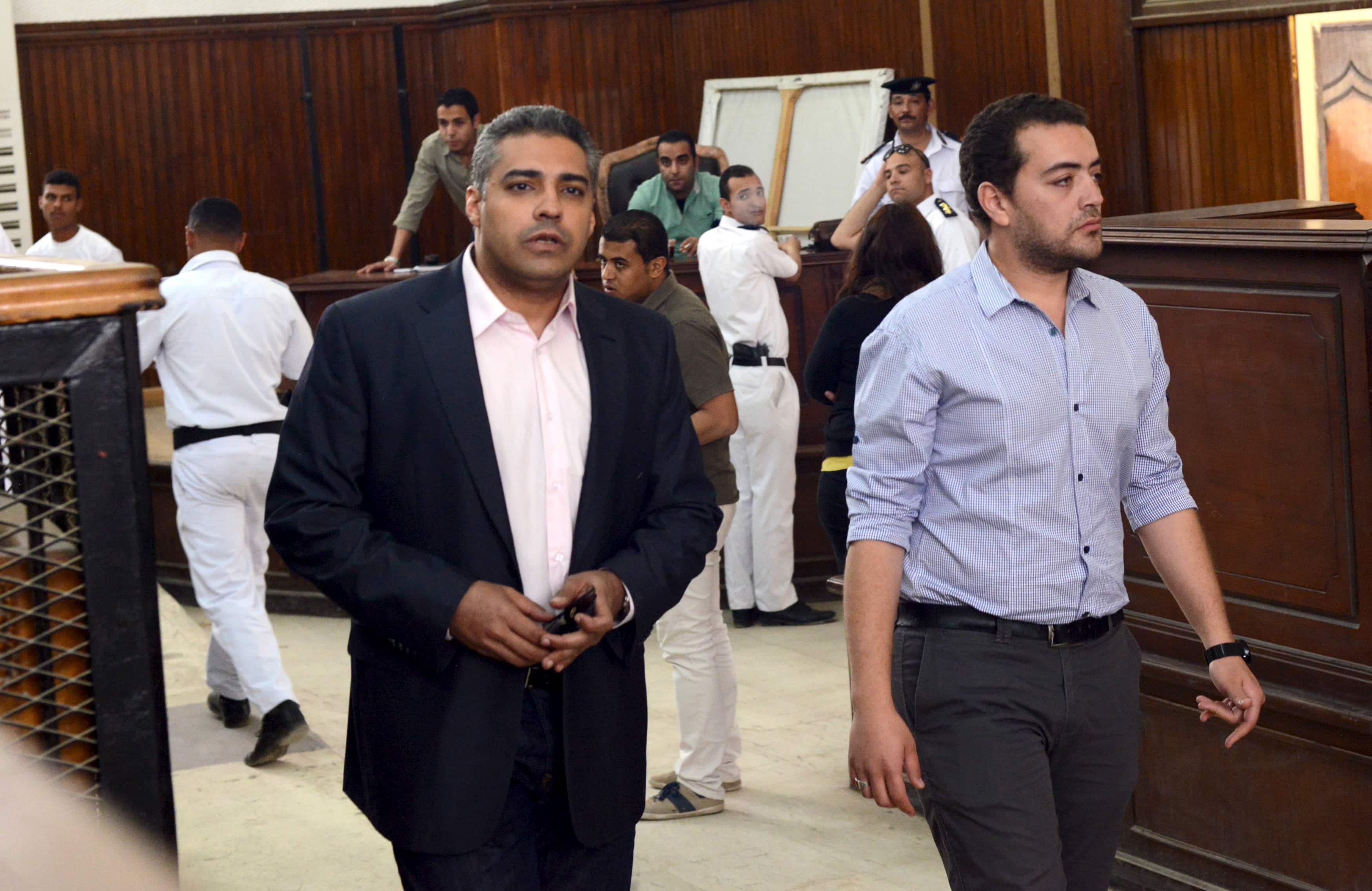 Al-Jazeera television journalists Mohamed Fahmy (L) and Baher Mohamed are seen at a court in Cairo after their retrial, April 22, 2015, REUTERS/Shadi Bushra