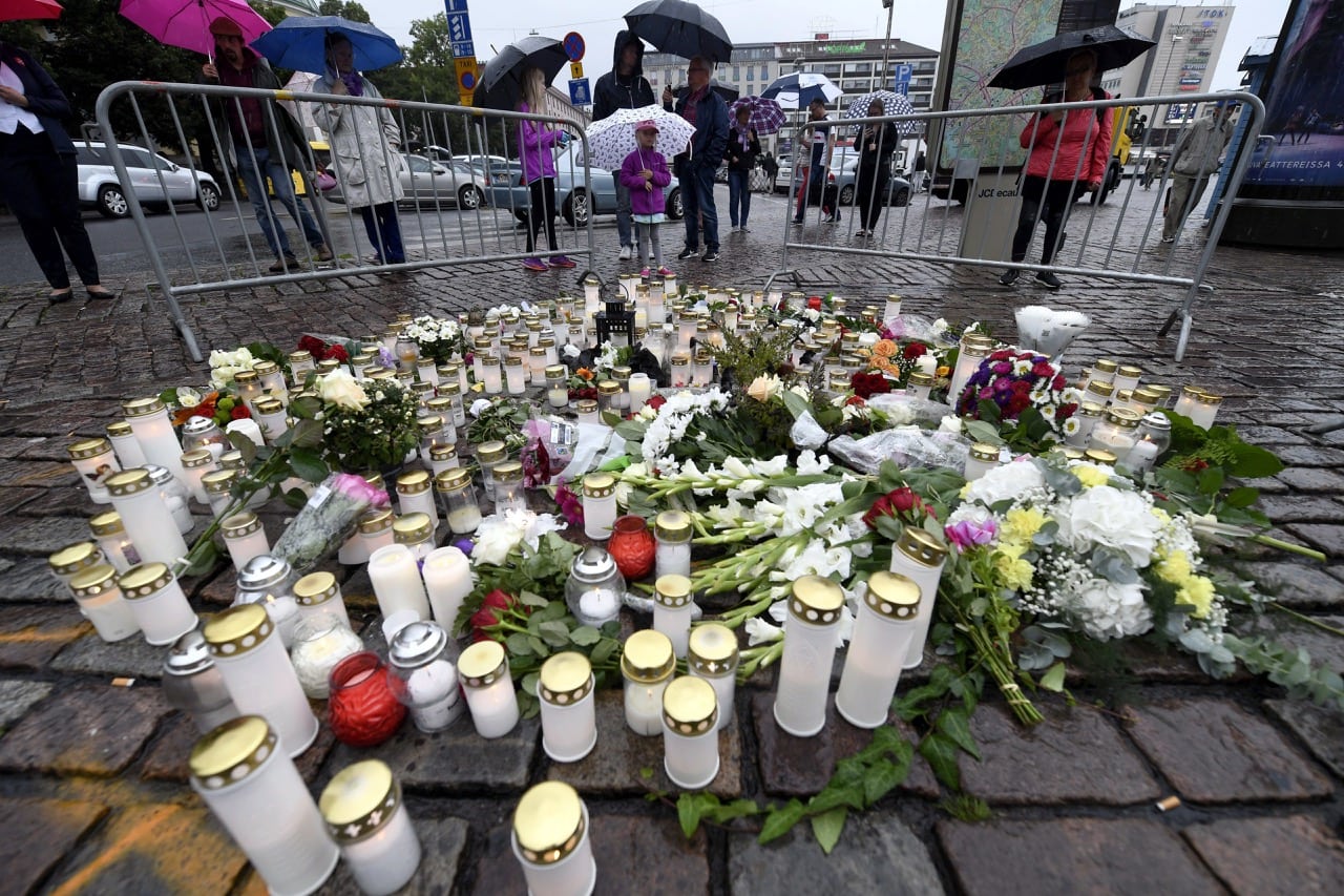 Candles and floral tributes left for the victims of an attack at Turku Market Square in Turku, Finland, 19 August 2017, Vesa Moilanen/Lehtikuva via AP