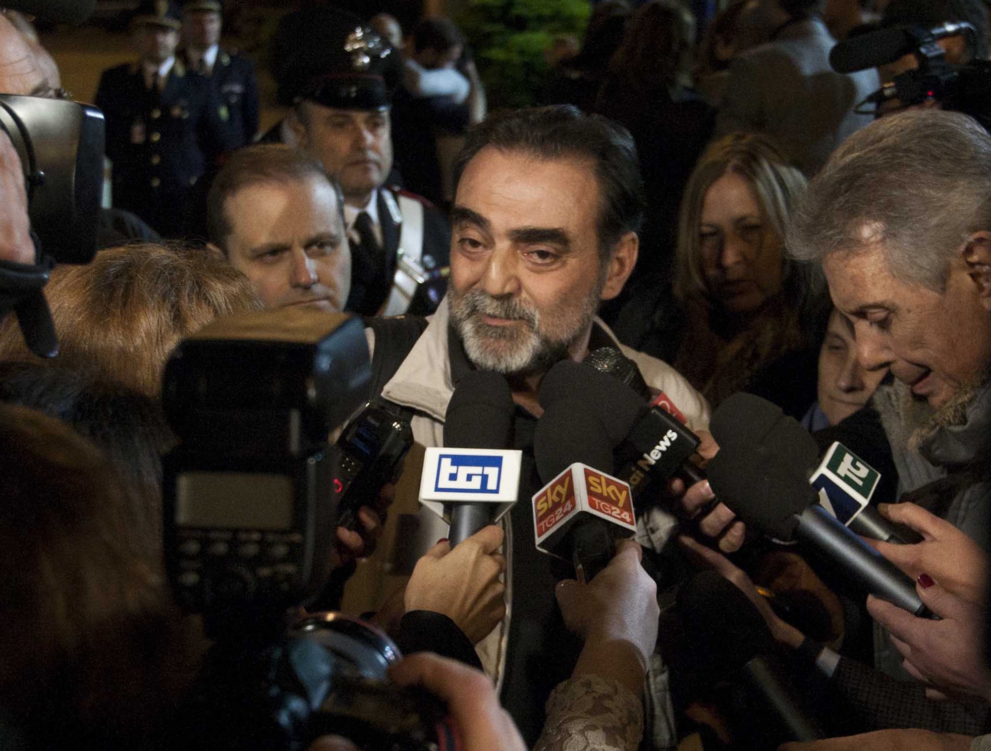 Italian journalist Amedeo Ricucci, who had been detained since 4 April, receives media attention as he arrives at the airport in Rome on 13 April 2013