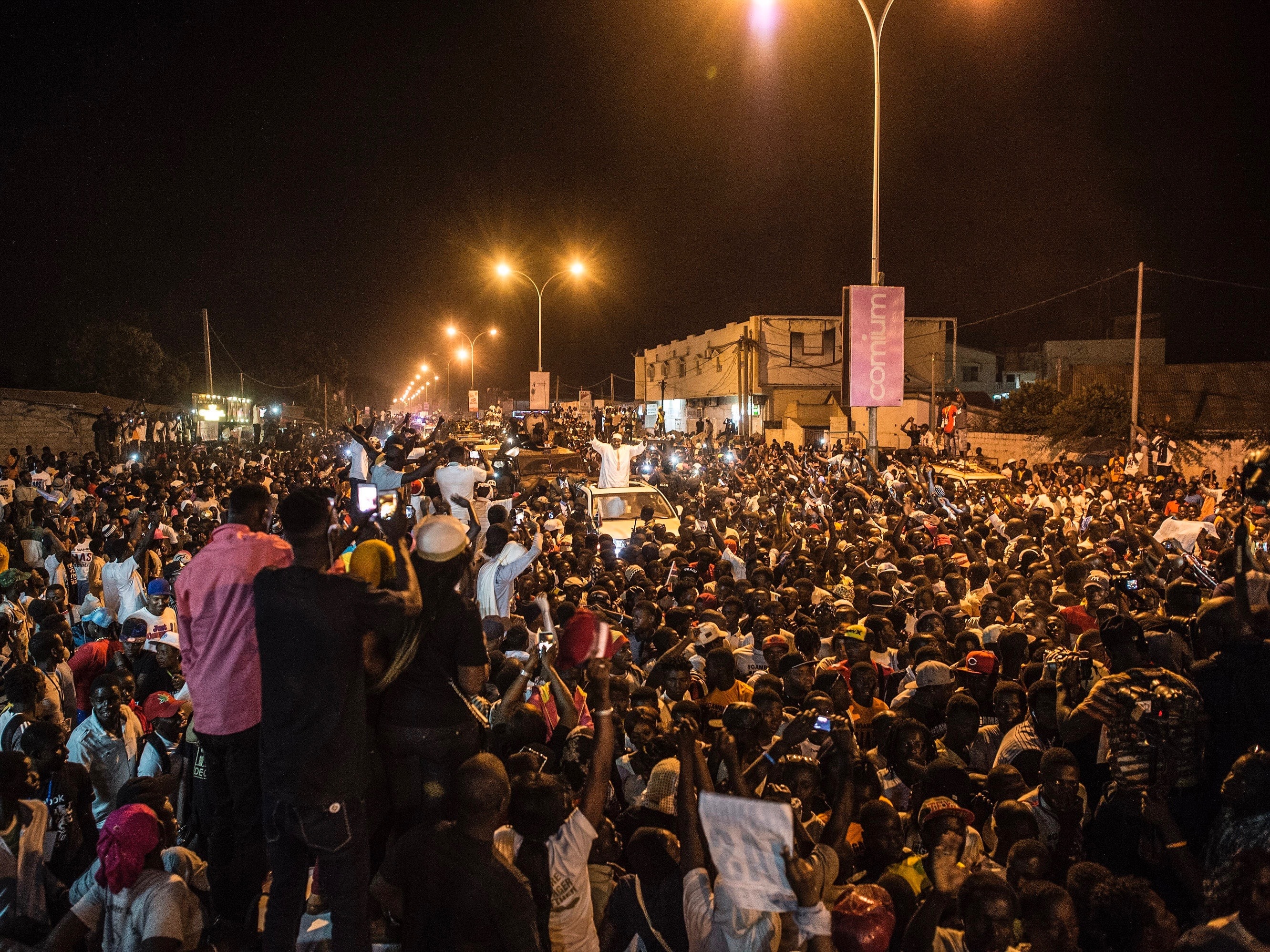 People cheer as President Adama Barrow, centre, arrives in the Westfield neighborhood of Serrekunda, Gambia, 26 January 2017, AP Photo/Sylvain Cherkaoui