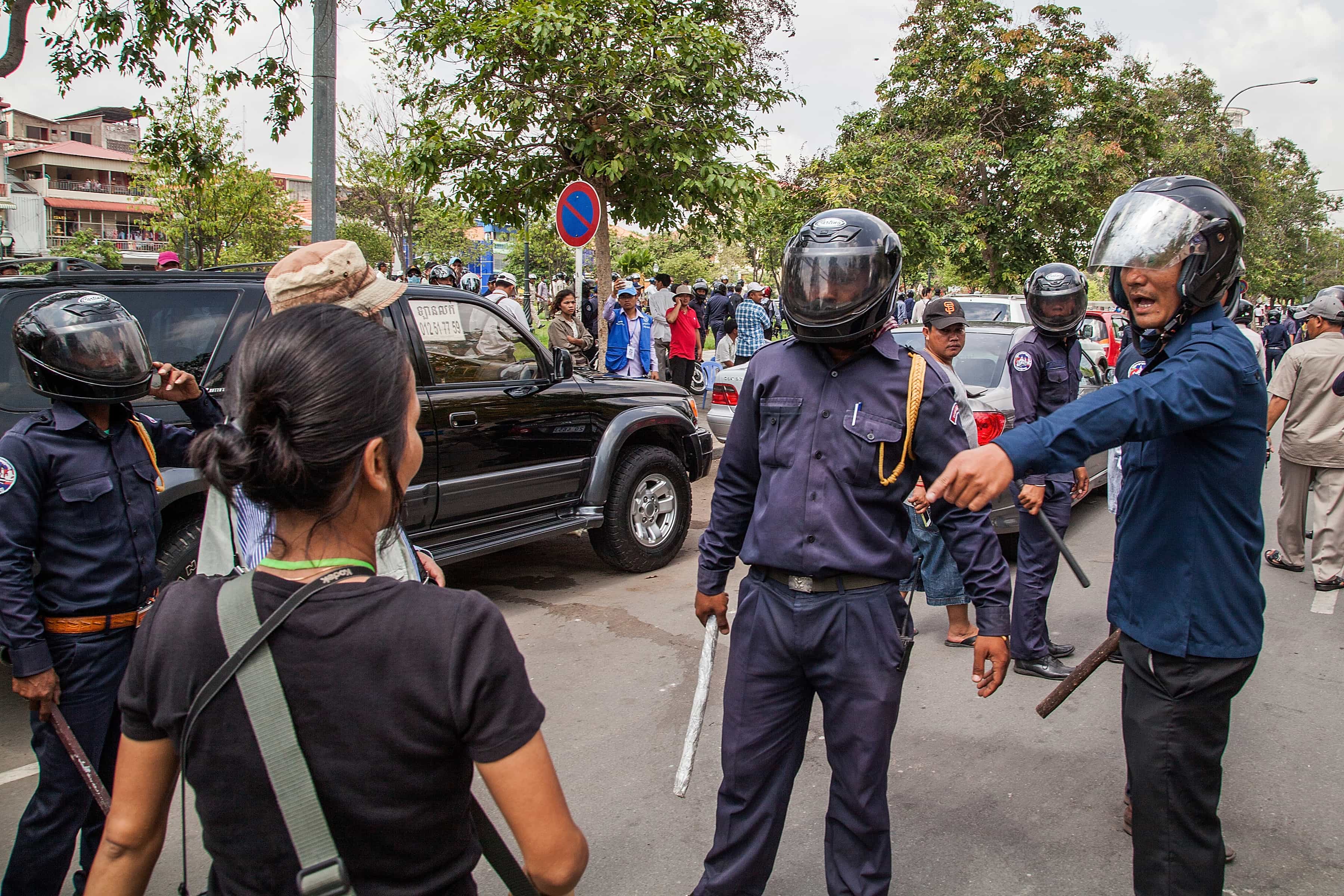 PHNOM PENH, CAMBODIA - MAY 01: Municipal security guards gestures towards a journalist during the Labor Day demonstration near Freedom Park on May 1, 2014 in Phnom Penh., Photo by Omar Havana/Getty Images