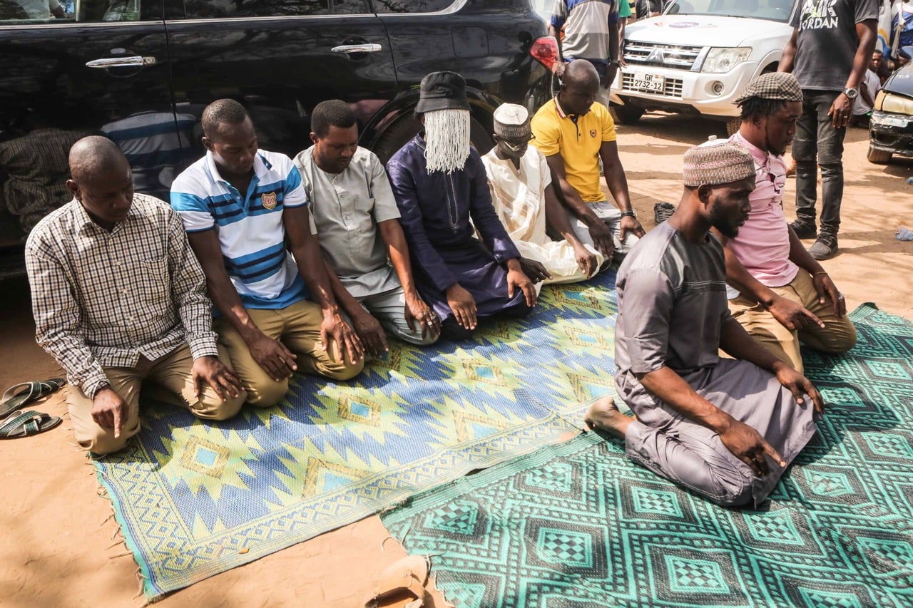 Investigative journalist Anas Aremeyaw Anas (C) prays alongside colleagues and friends for his colleague Ahmed Husein Suale, in Accra, Ghana, 18 January 2019, RUTH MCDOWALL/AFP/Getty Images