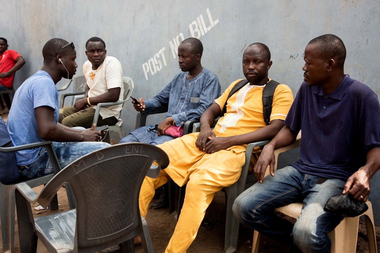 Mansuru Tahiru (2nd R), the cousin of murdered Ghanian undercover reporter Ahmed Hussein Suale, sits with friends during a mourning gathering in Accra, 17 January 2019, RUTH MCDOWALL/AFP/Getty Images