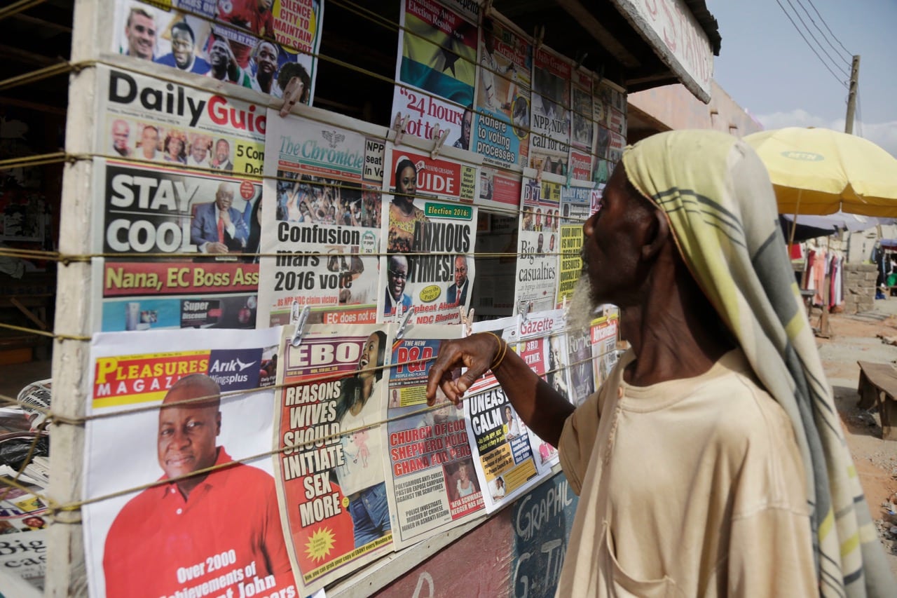 A man looks at local newspapers on a street in Accra, Ghana, 9 December 2016, AP Photo/Sunday Alamba