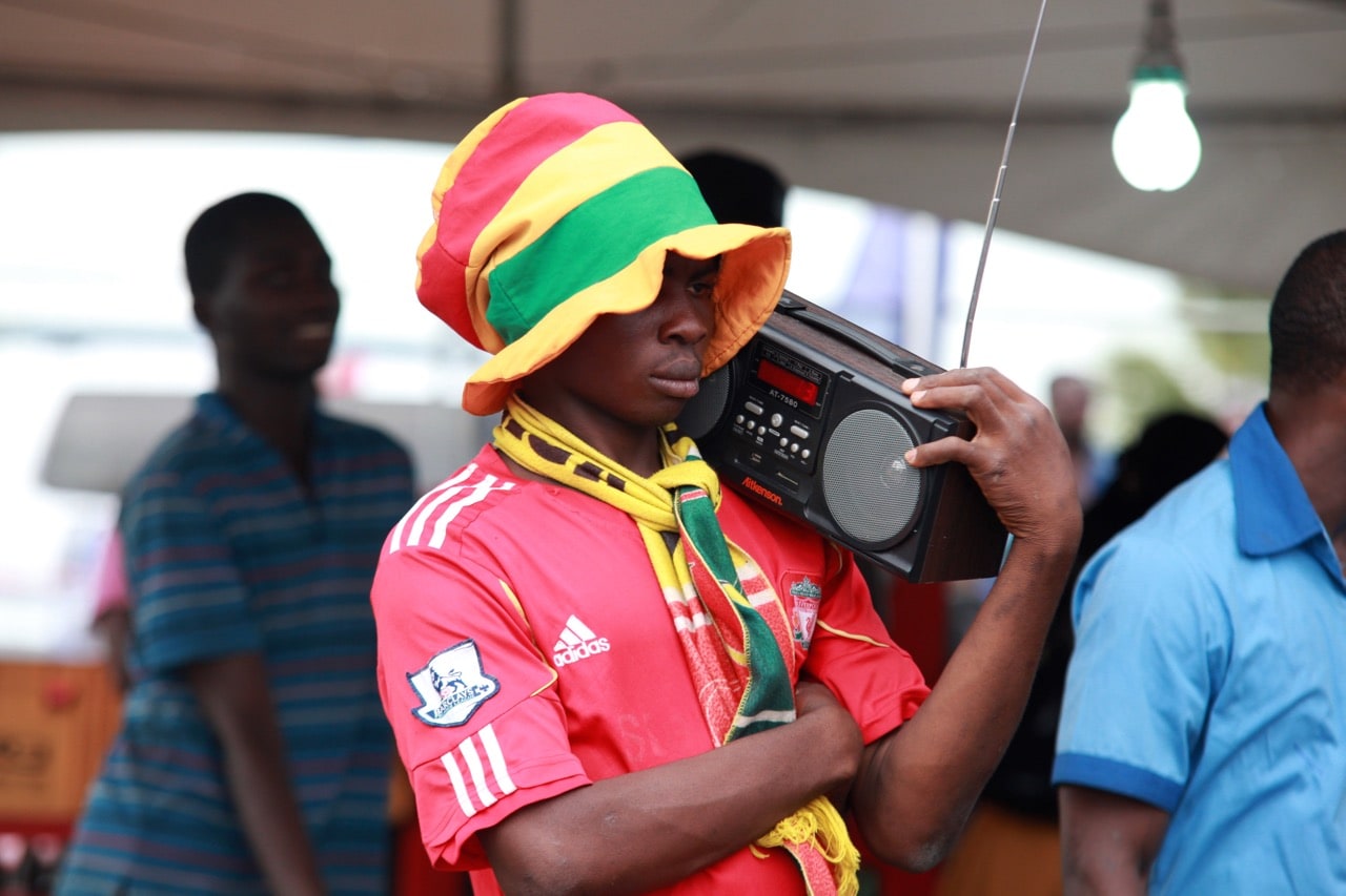 A Ghanaian fan listens to live commentary on the radio at the soccer village in Accra, Ghana, 26 June 2014, AP Photo/Christian Thompson