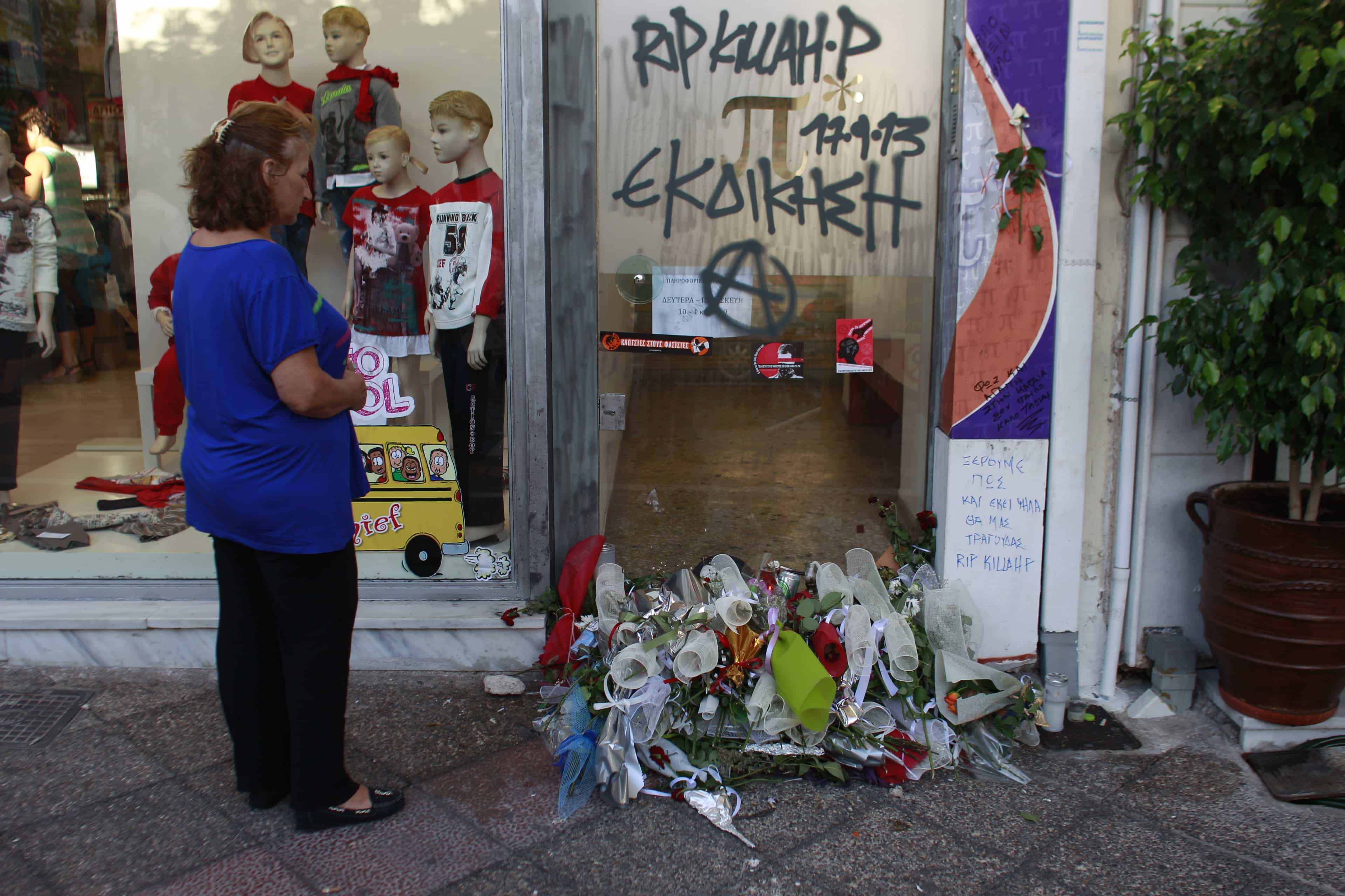 A woman stands in front of the site where Pavlos Fyssas died early Wednesday, at the suburb of Keratsini near Athens on 19 September 2013., AP Photo/Kostas Tsironis