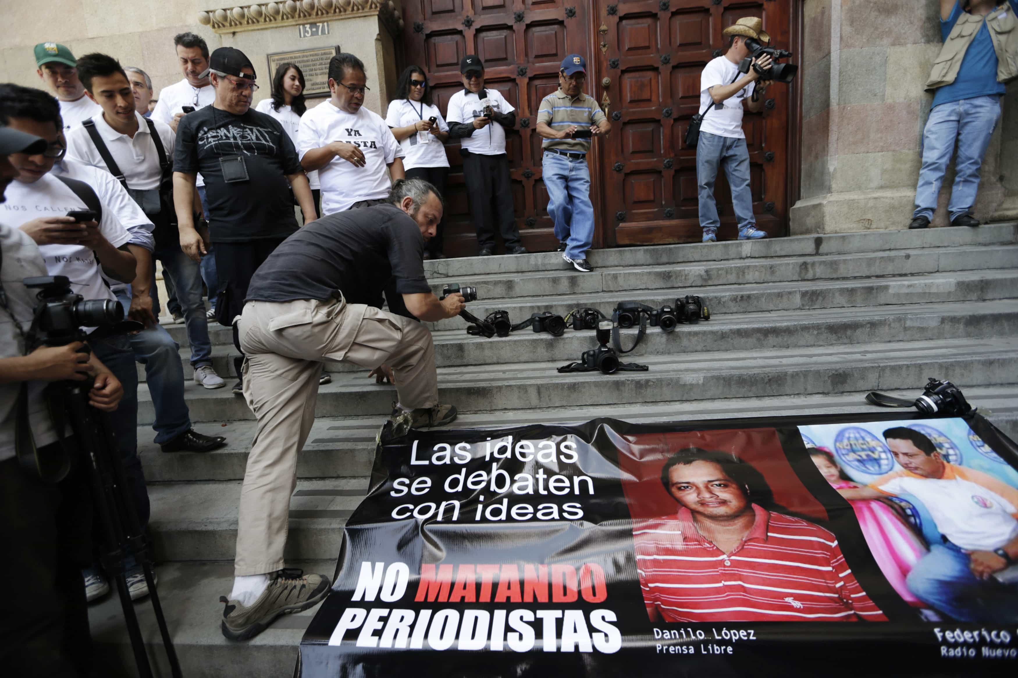 Journalists lay their cameras outside the entrance of the Interior Ministry during a protest against the killing of three journalists in Guatemala City, March 15, 2015, REUTERS/Jorge Dan Lopez