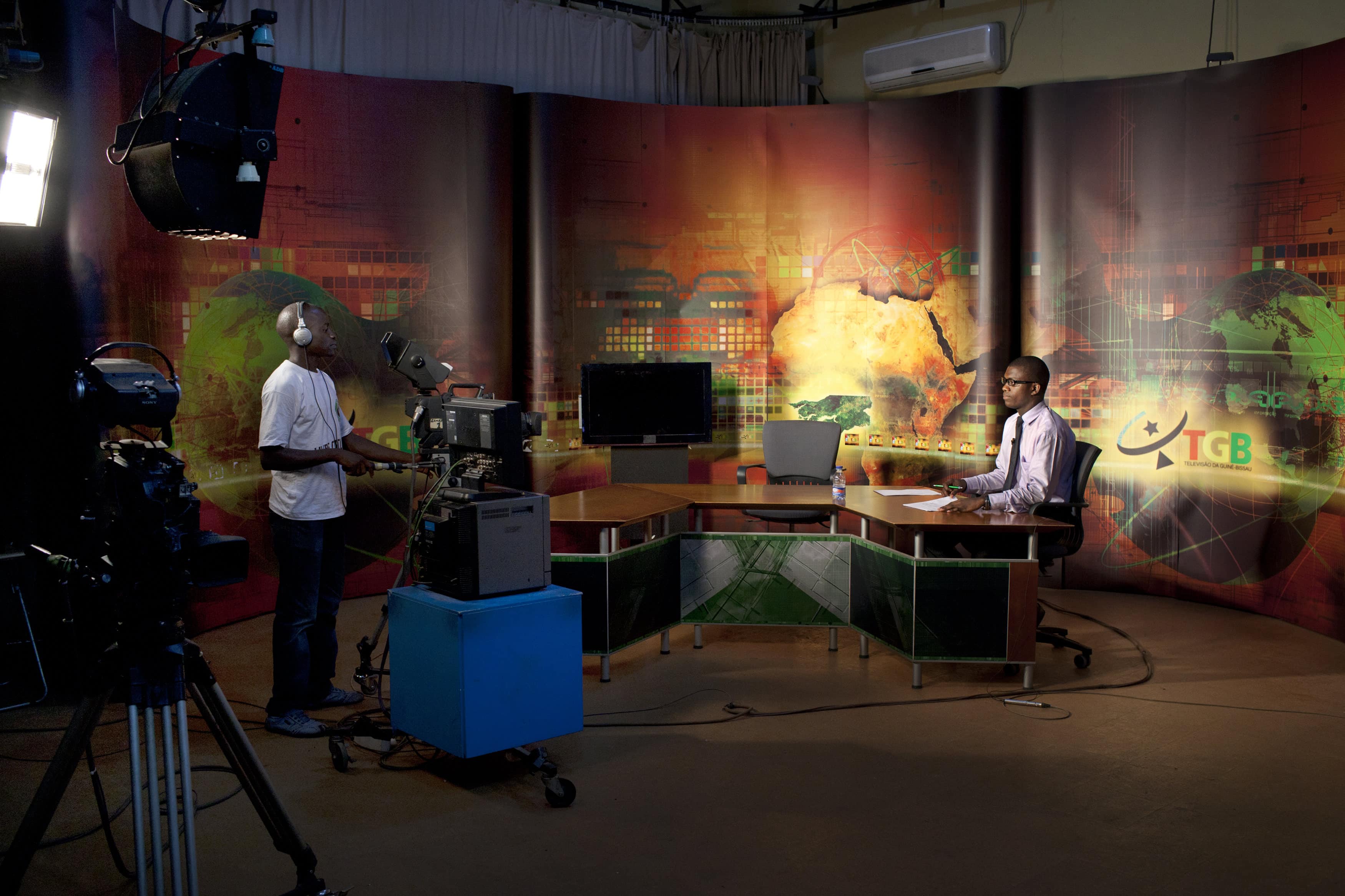 A newscaster reads the news during a broadcast of Guinea-Bissau's national television in the capital, Bissau, 29 October 2012, REUTERS/Joe Penney