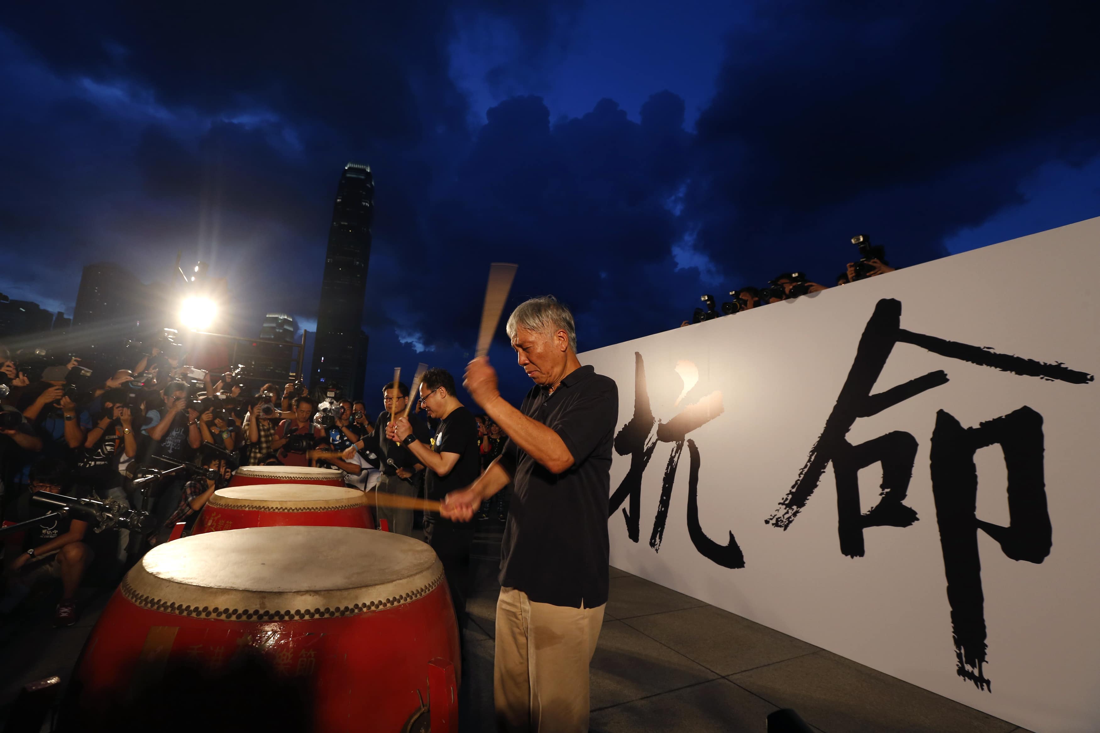 Founders of the Occupy Central movement are pictured in front of the Chinese characters for "disobedience", during the kick off of the campaign in front of the financial Central district in Hong Kong, 31 August 2014, REUTERS/Bobby Yip