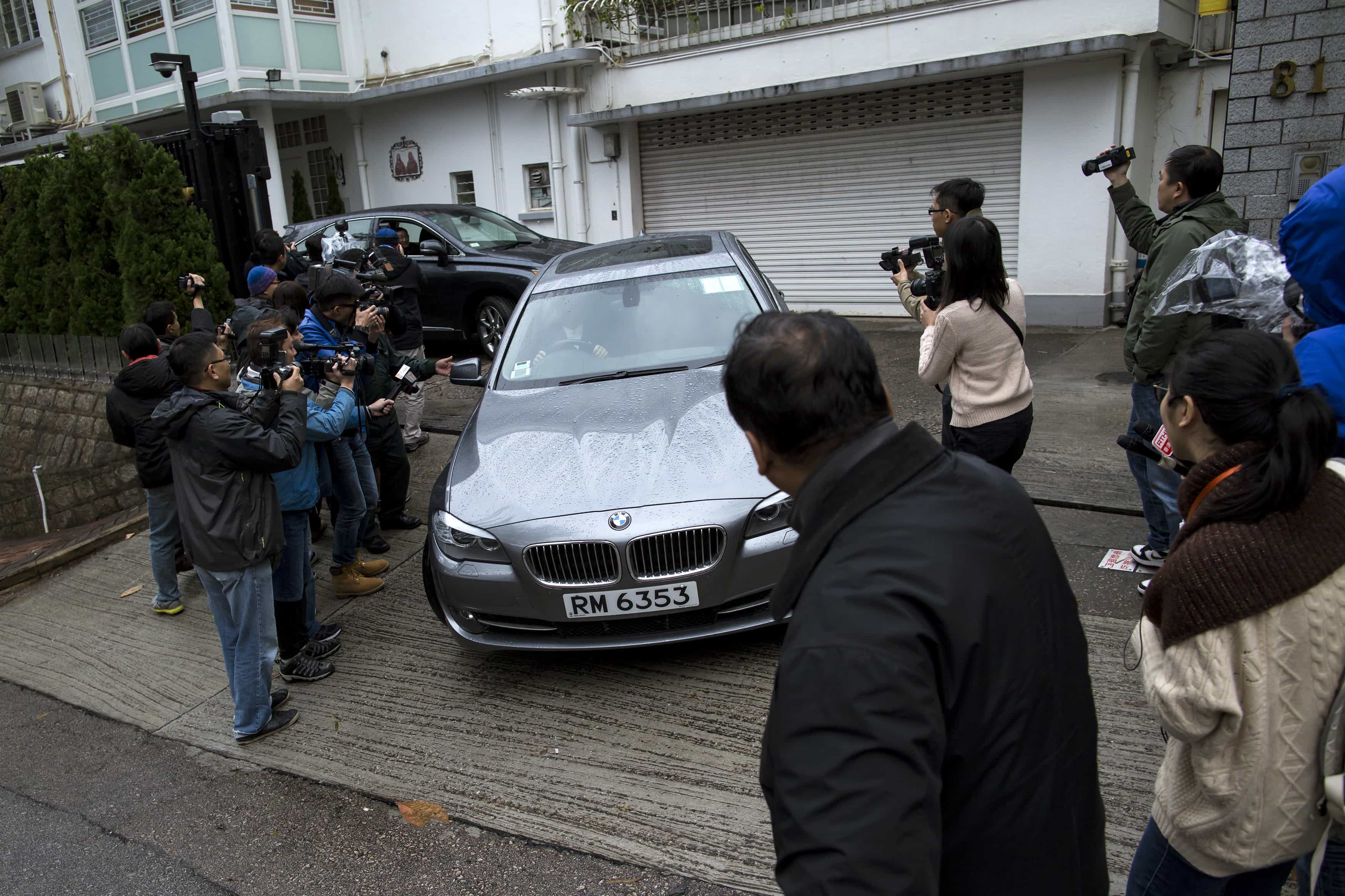 Journalists surround a car outside the house of of Hong Kong media tycoon Jimmy Lai in Hong Kong, 12 January 2015, REUTERS/Tyrone Siu