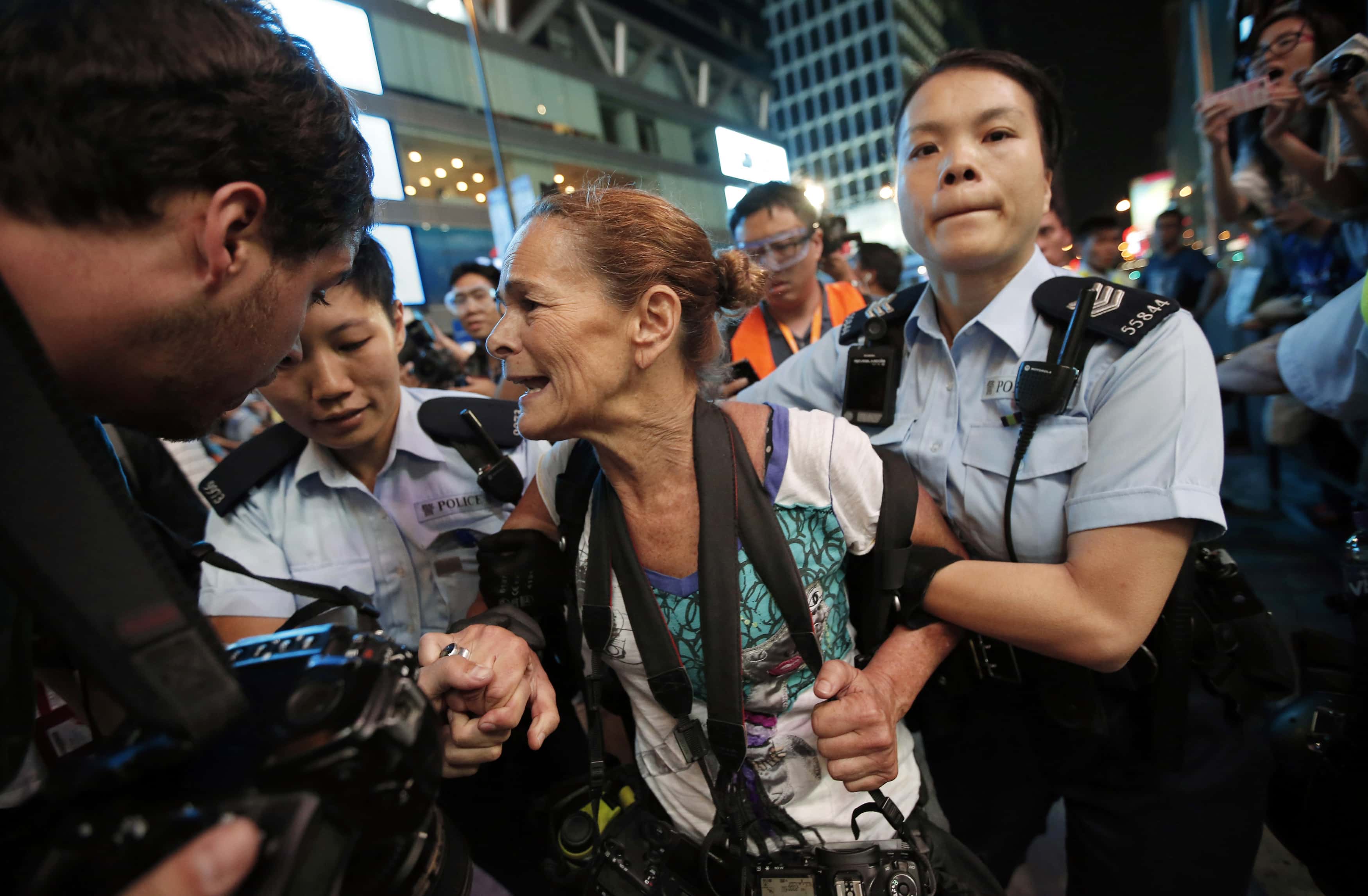 Police officers detain Getty Images photographer Paula Bronstein during a confrontation between police and pro-democracy protesters at Mongkok shopping district in Hong Kong, 17 October 2014, REUTERS/Carlos Barria