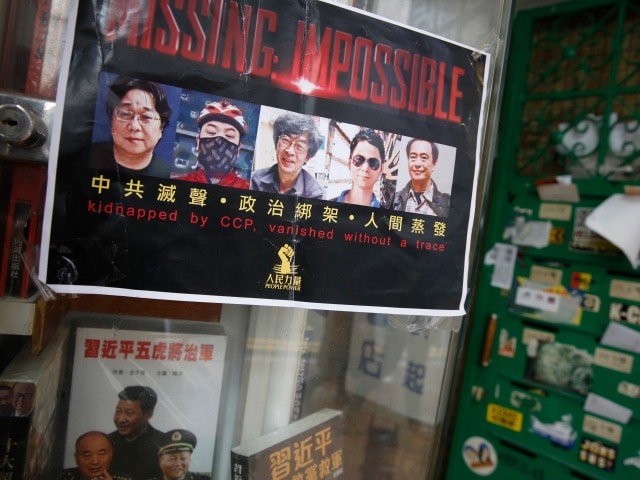 A poster featuring five missing Hong Kong booksellers is displayed at the entrance of the closed Causeway Bay Bookstore, in Hong Kong, 5 February 2016, AP Photo/Kin Cheung
