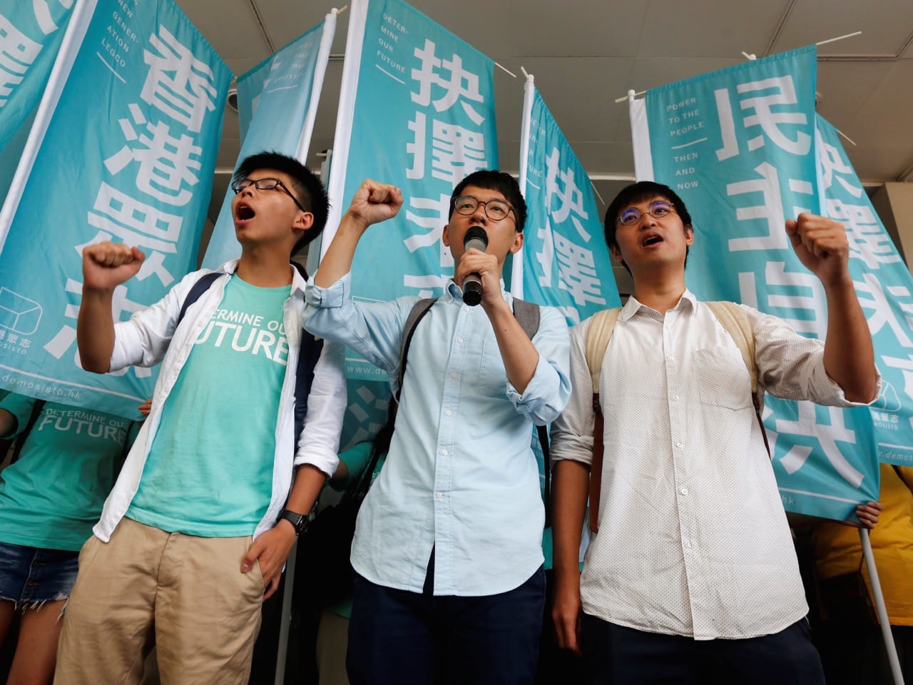 tudent leaders (from L) Joshua Wong, Nathan Law and Alex Chow chant slogans before a verdict, outside a court in Hong Kong 21 July 2016 , REUTERS/Bobby Yip