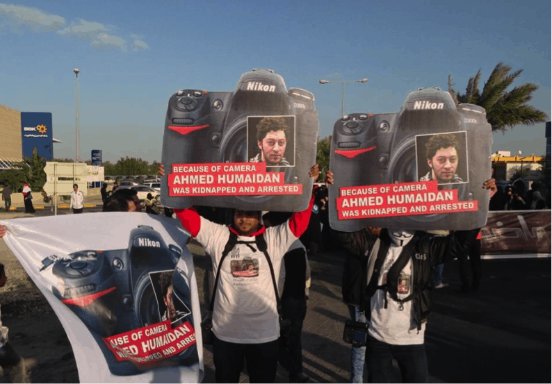 Protesters in Bahrain hold up posters of Ahmed Humaidan in a show of solidarity with the prominent Bahraini photojournalist, Bahrain Centre for Human Rights