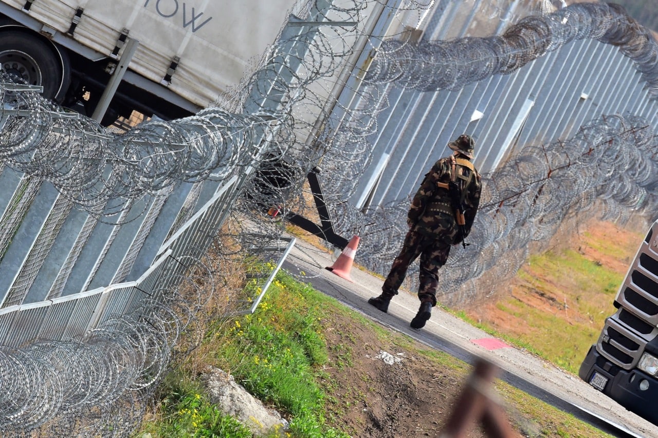 A Hungarian soldier patrols at the Hungarian border fence at the Tompa border station transit zone on 6 April 2017, ATTILA KISBENEDEK/AFP/Getty Images