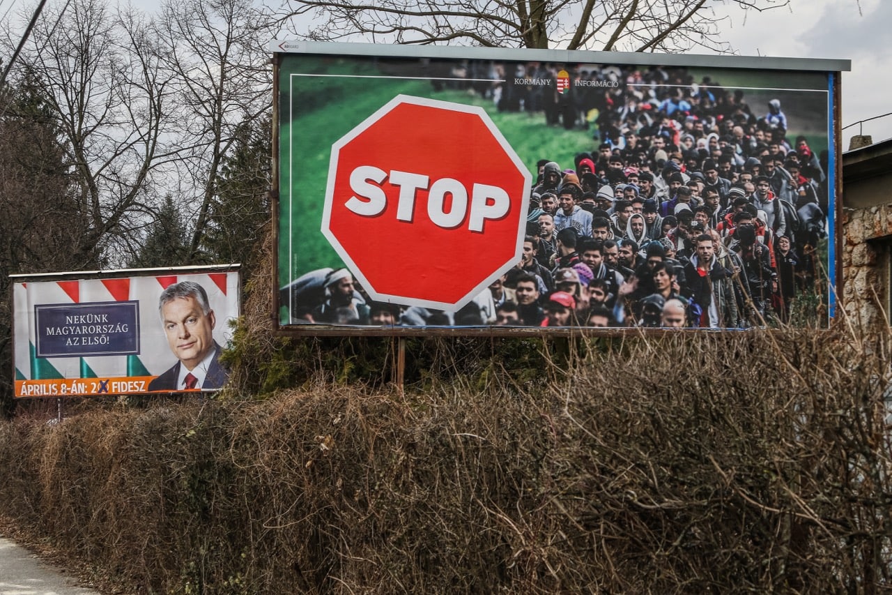 A Viktor Orban electoral poster together with an official government anti-immigrants banner is seen in Miskolc, Hungary, 31 March 2018, Michal Fludra/NurPhoto via Getty Images