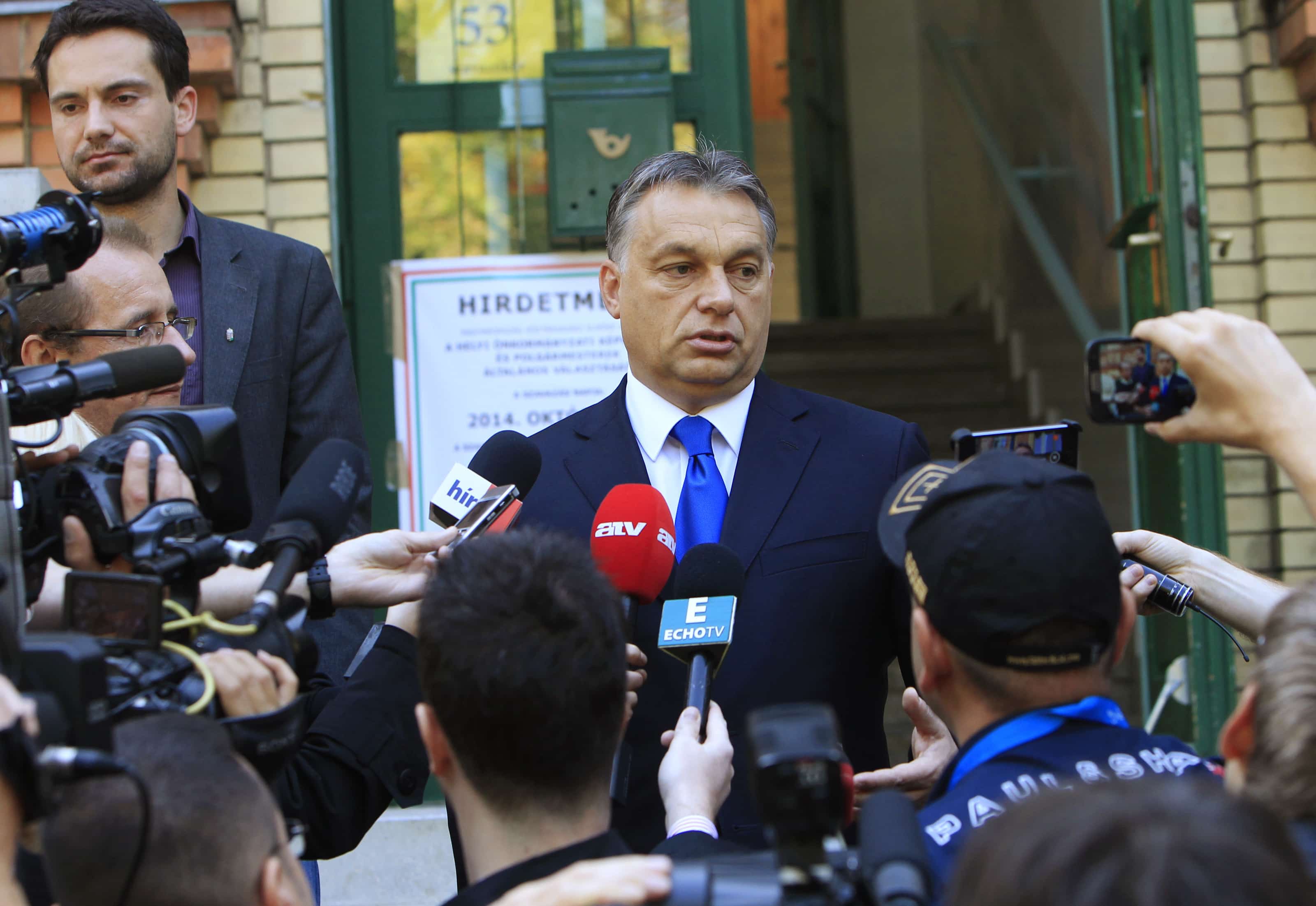 Hungary's Prime Minister Viktor Orban talks to journalists after casting his vote during Hungary's municipal elections in Budapest, October 12, 2014, REUTERS/Bernadett Szabo