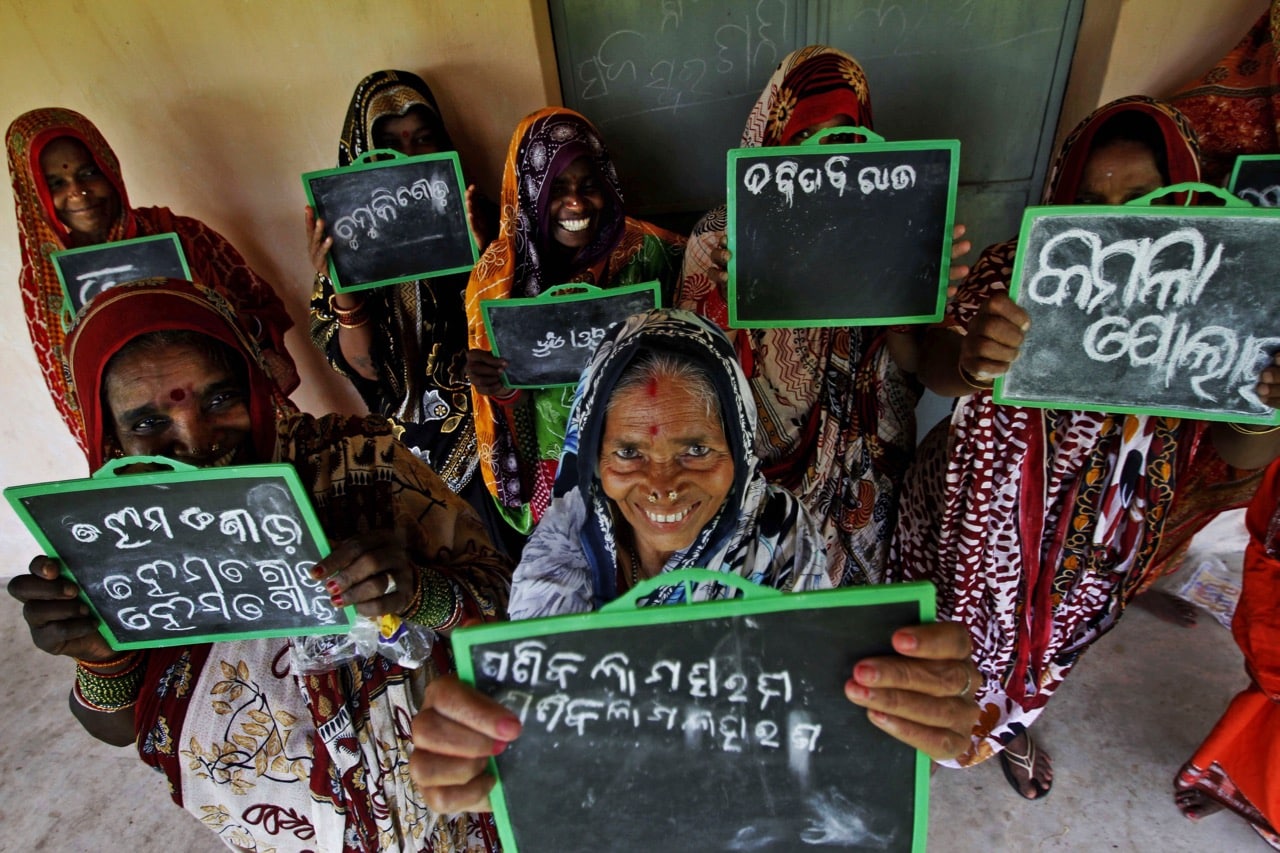 Women pose with their slates as they attend a free school for illiterate women, in Dhunkapada village, Orissa state, India, 8 September 2014, AP Photo/Biswaranjan Rout