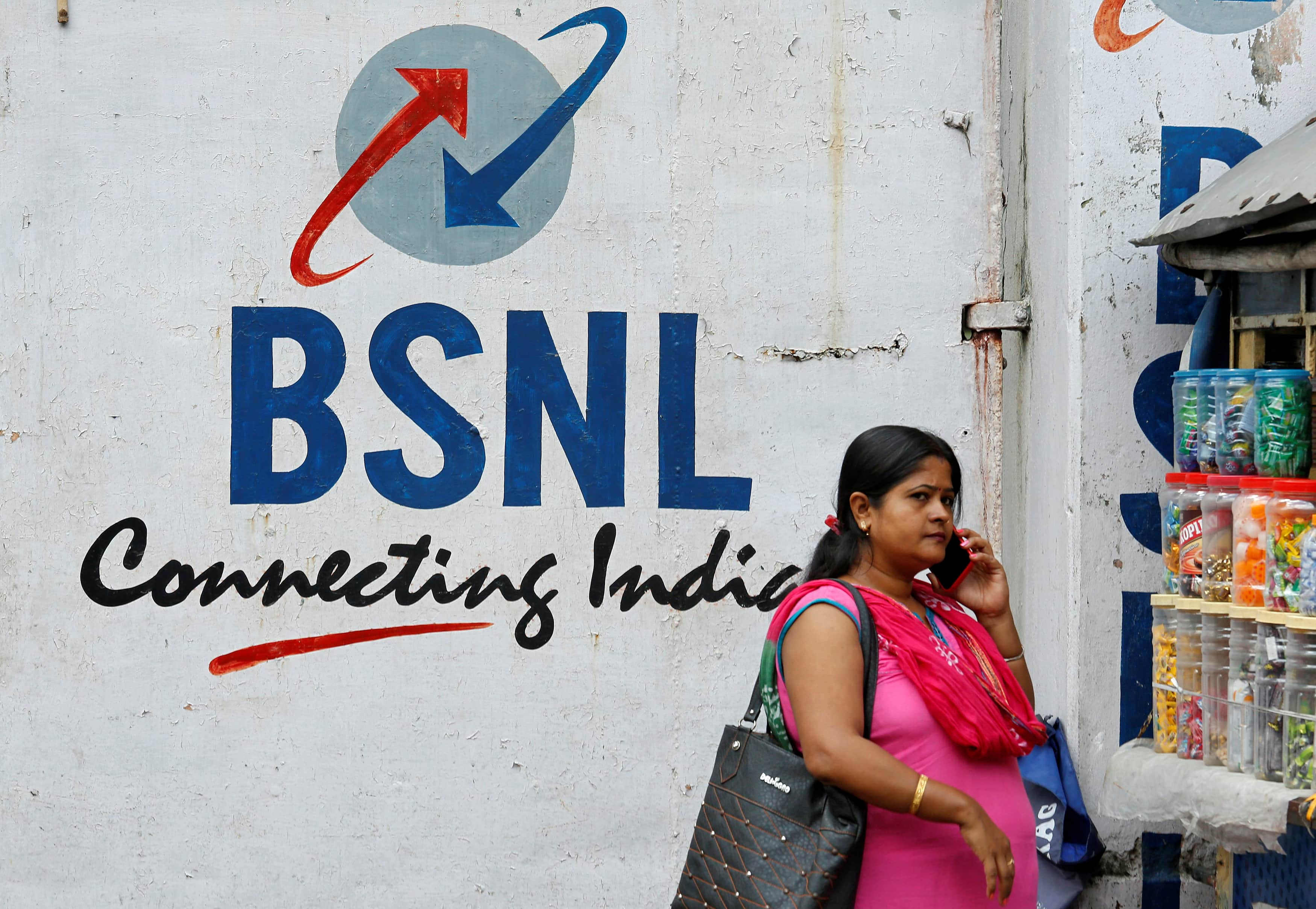 A woman speaks on her mobile phone in front of the logo of Bharat Sanchar Nigam Ltd (BSNL) outside its office in Kolkata, India, 24 August 2017, REUTERS/Rupak De Chowdhur