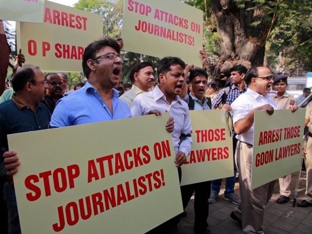 Indian journalists hold placards during a 17 January 2016 protest in Mumbai against an attack on journalists in New Delhi, AP Photo/Rafiq Maqbool