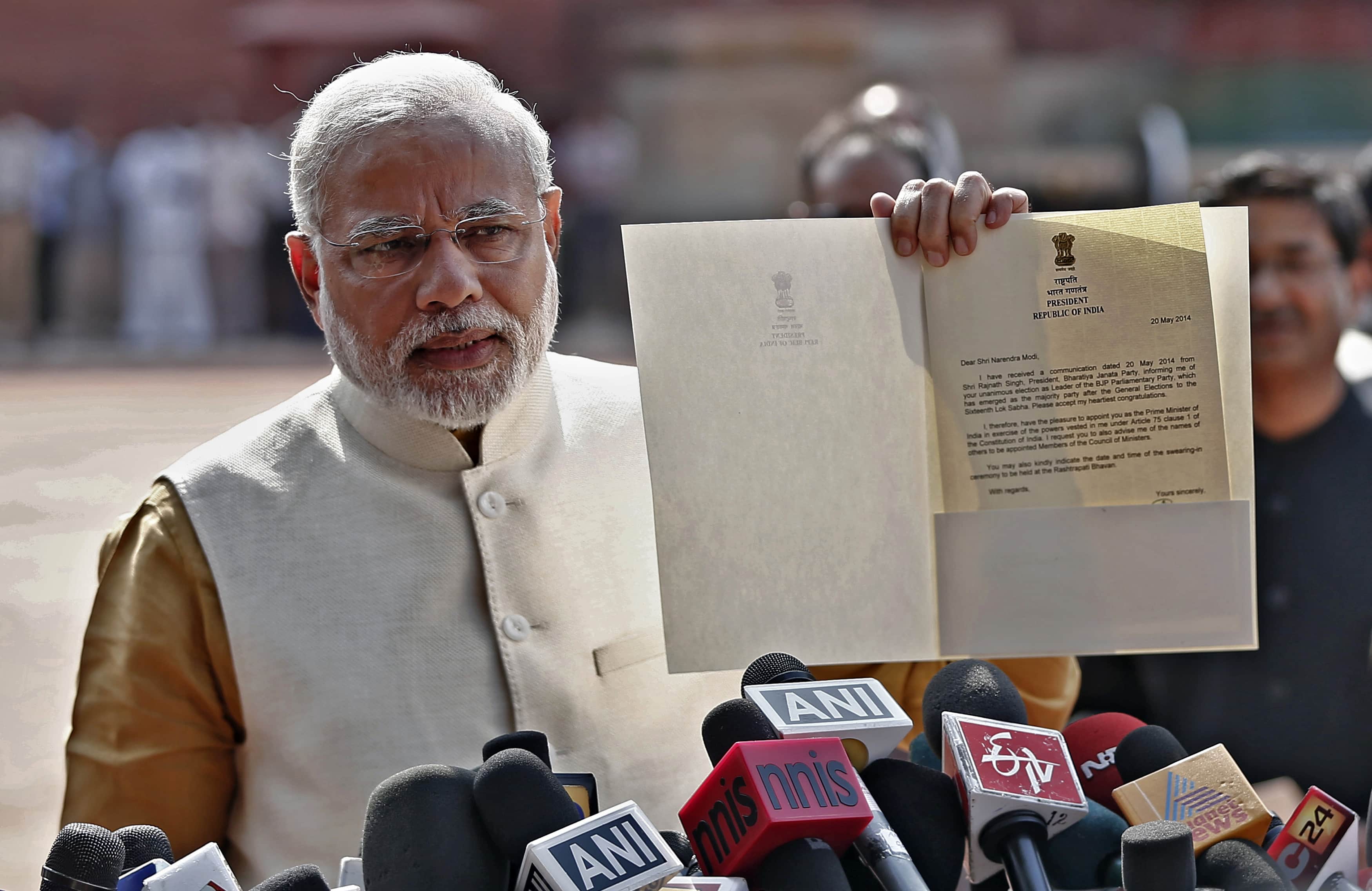 Hindu nationalist Narendra Modi, who will be the next prime minister of India, shows the media a letter he received from India's President Pranab Mukherjee after meeting him at the Presidential Palace in New Delhi, 20 May 2014, REUTERS/Adnan Abidi