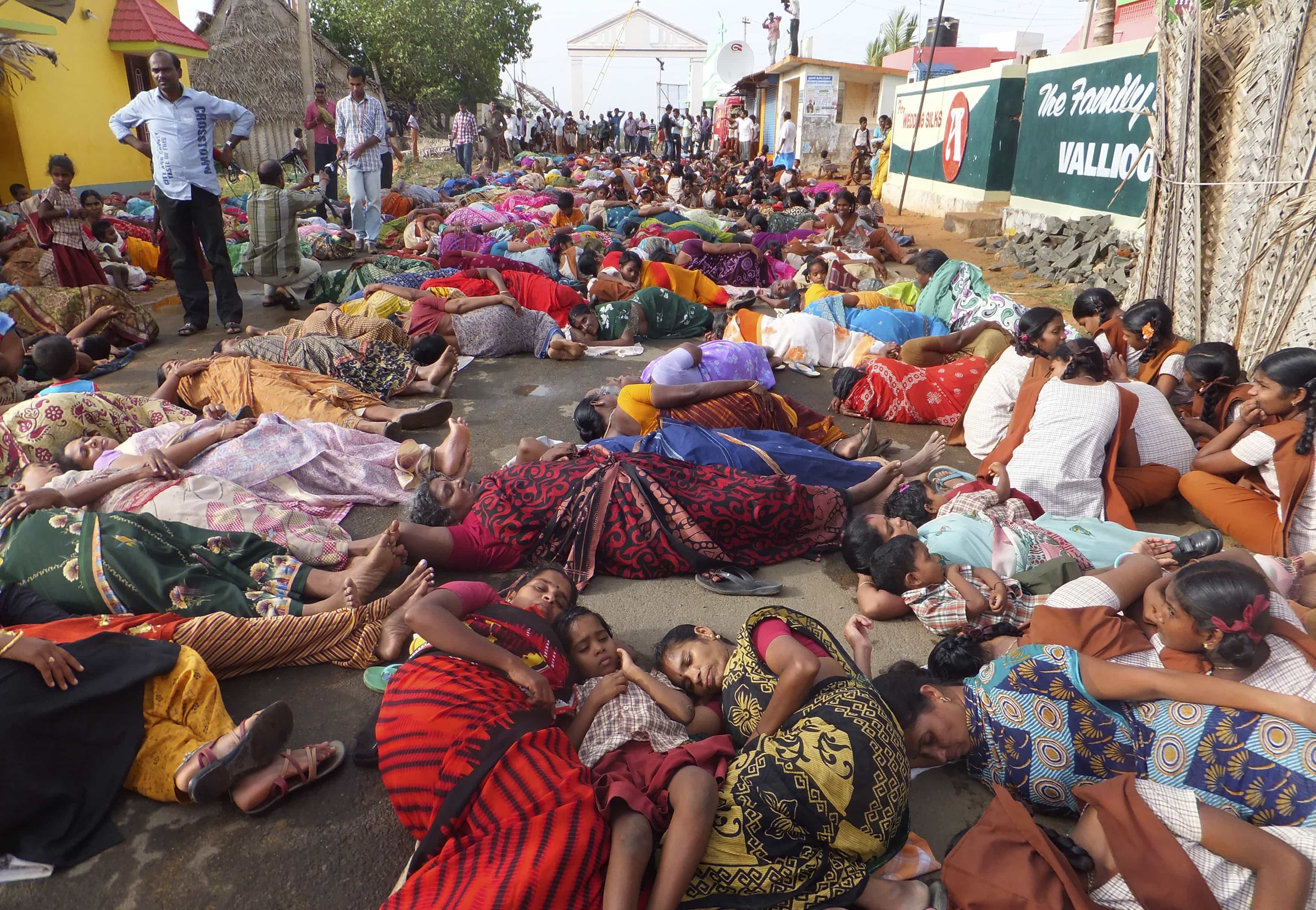 Demonstrators lie on a road during a protest near the Kudankulam nuclear power project, in the southern Indian state of Tamil Nadu, 15 July 2013, REUTERS/Stringer