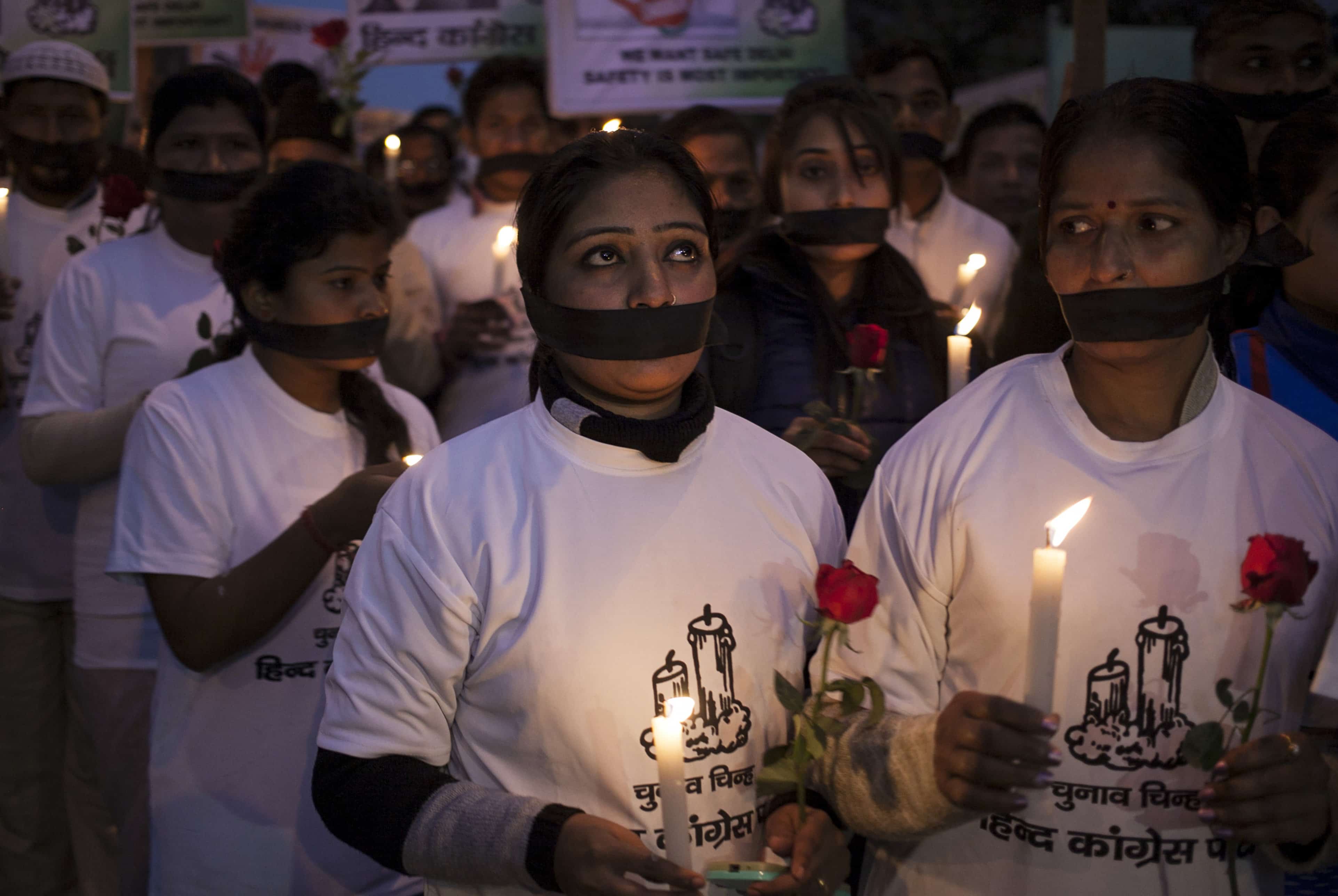 On 16 December 2014, Indian women participate in a vigil in New Delhi at the bus stop where Jyoti Singh had boarded the bus two years earlier, AP Photo/Tsering Topgyal