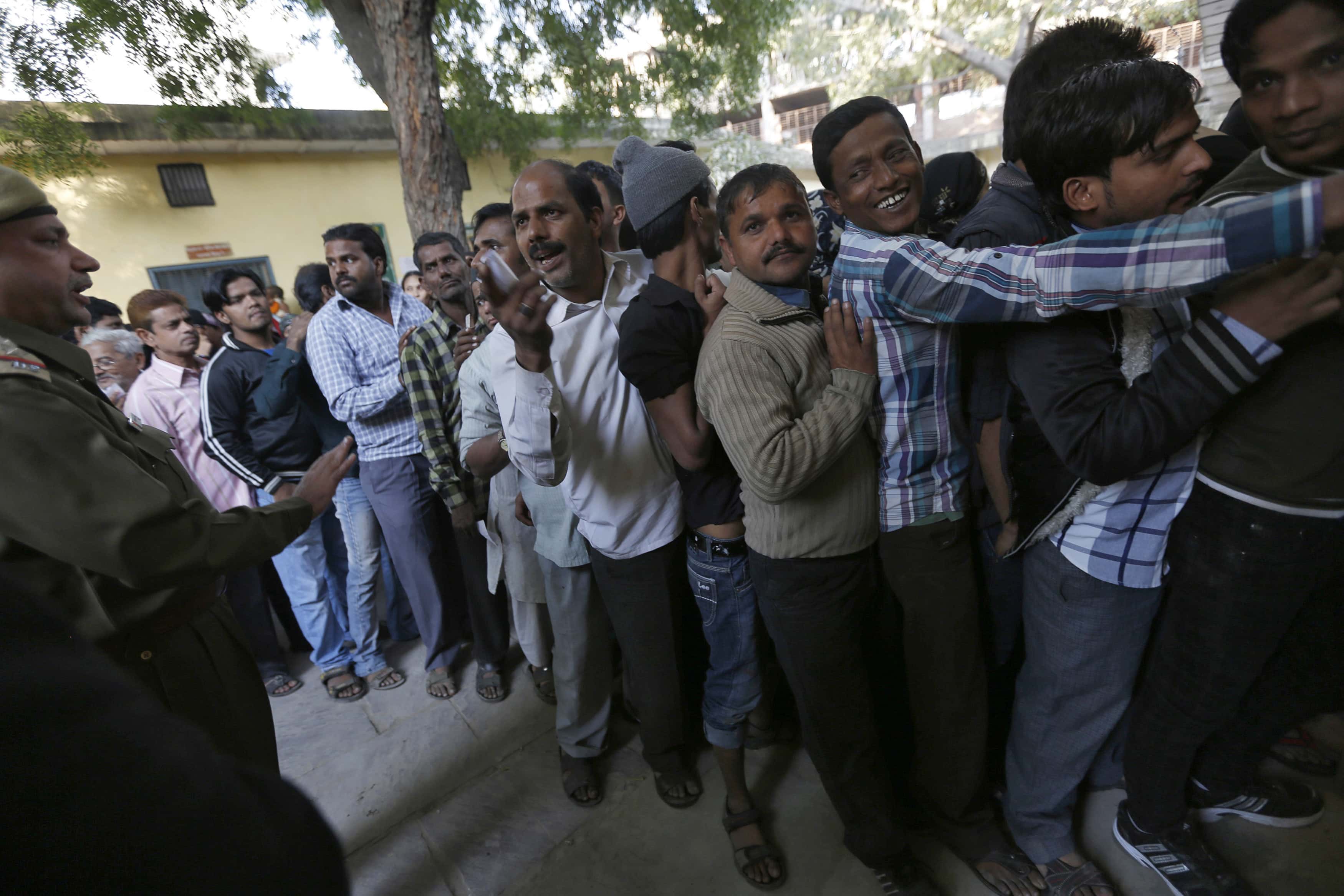 Voters line up in a queue outside a polling booth to cast their vote during the state assembly election in the old quarters of Delhi, 4 December 2013, REUTERS/Ahmad Masood