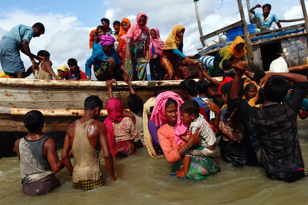Rohingya refugees get off a boat after crossing the Bangladesh-Myanmar border through the Bay of Bengal, in Shah Porir Dwip, Bangladesh, 11 September 2017, REUTERS/Danish Siddiqui