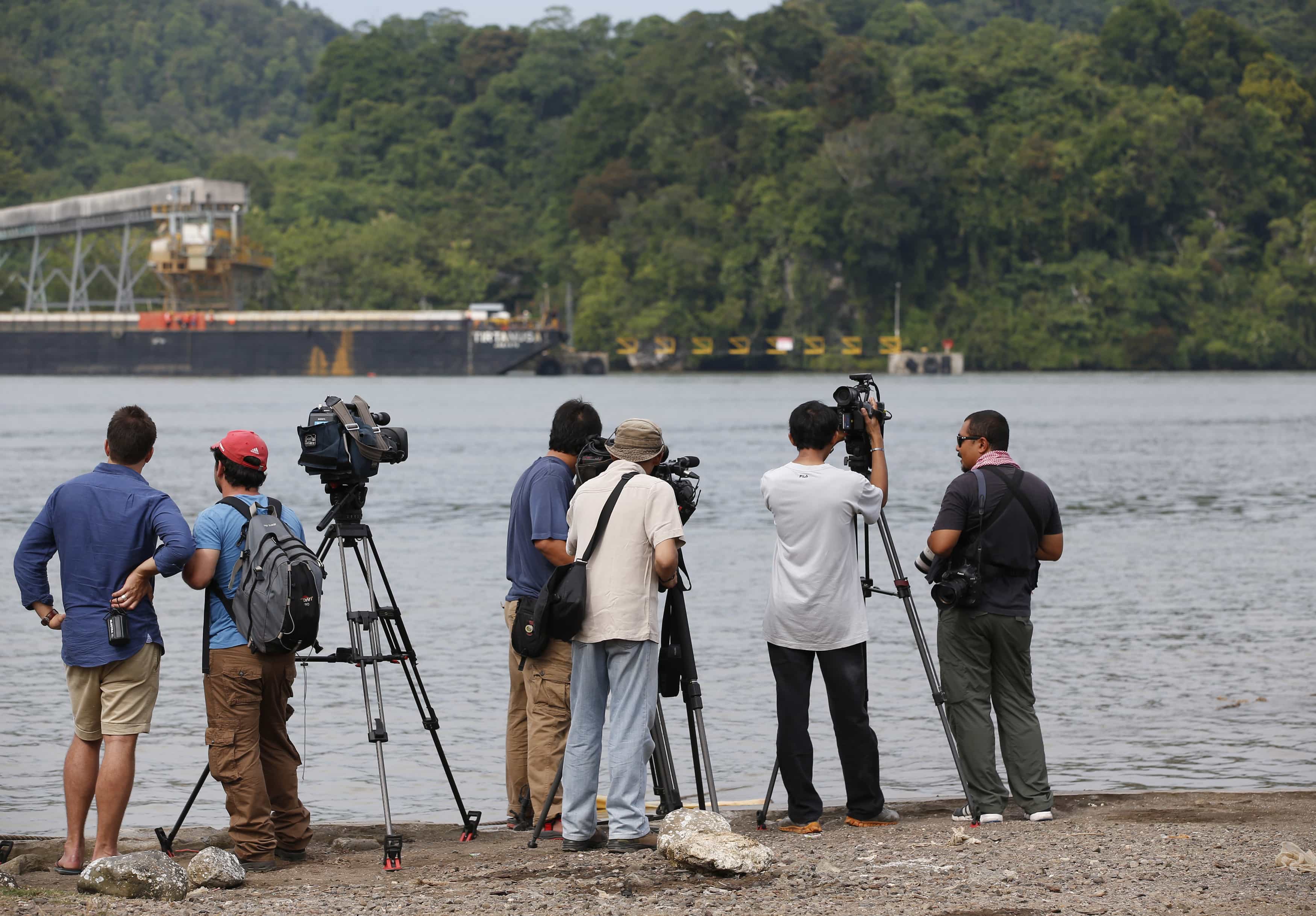 Journalists stand on the shore across from the prison island of Nusakambangan, in Central Java, 7 March 2015, REUTERS/Darren Whiteside