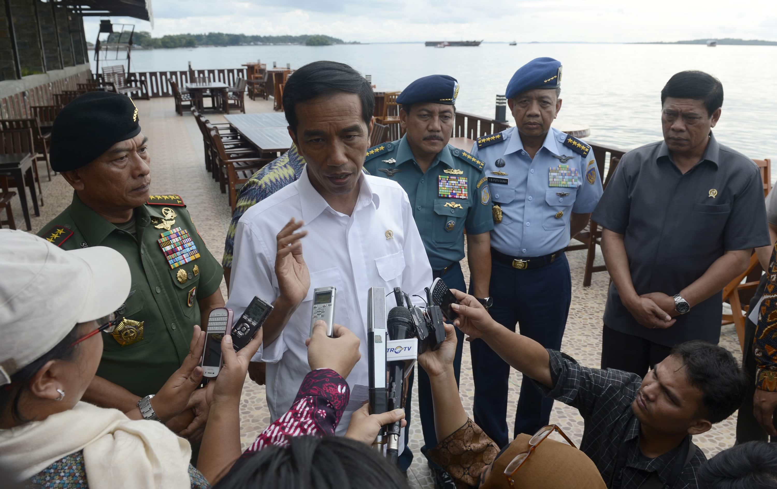 Indonesian President Joko Widodo (C) speaks to the media in Sorong, West Papua 28 December 2014 in this photo taken by Antara Foto, REUTERS/Antara Foto/Prasetyo Utomo