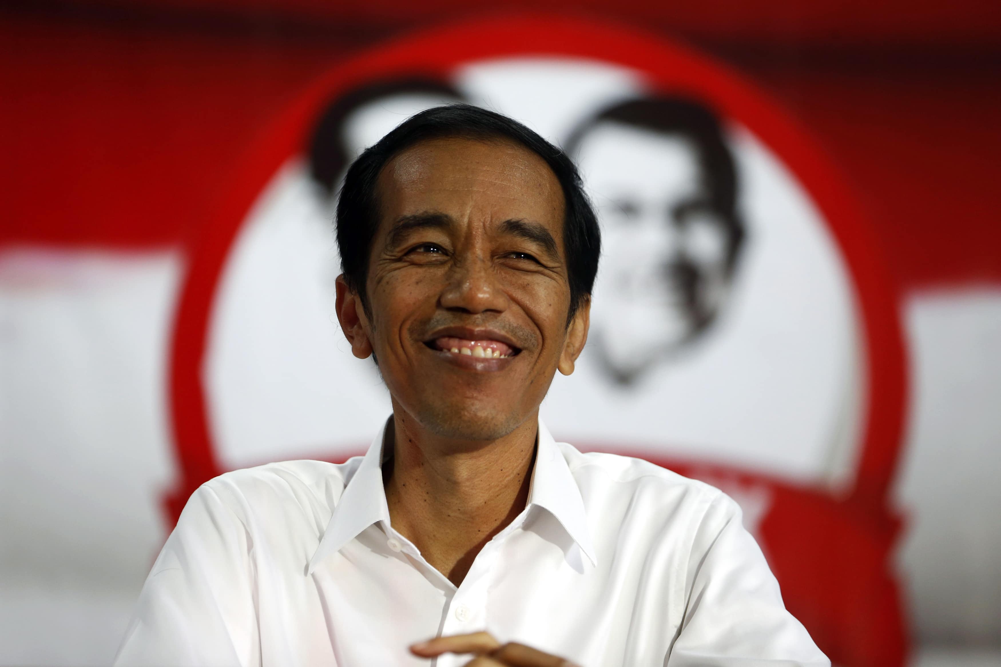 Then presidential candidate Joko Widodo smiles during a speech to his supporters in Serang, Indonesia's Banten province, 16 July 2014, REUTERS/Beawiharta