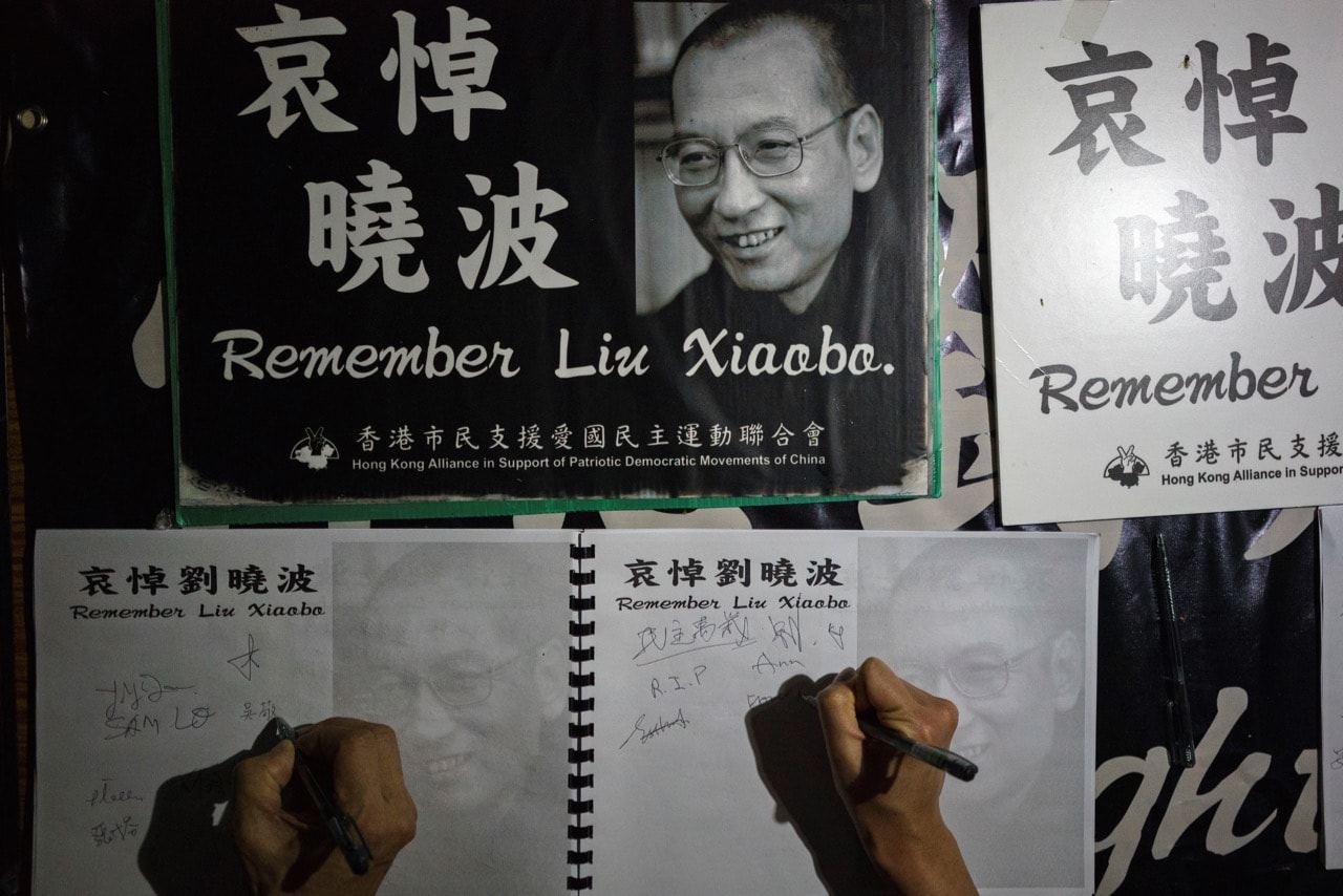 People sign their names at a memorial event for the late Chinese Nobel laureate Liu Xiaobo in Hong Kong, 19 July 2017, AARON TAM/AFP/Getty Images