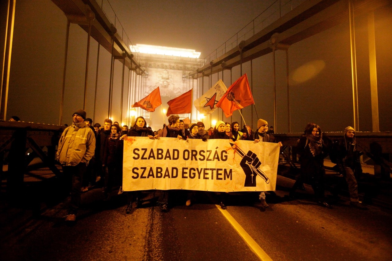 Demonstrators cross the Chain Bridge during a protest against the dubbed 'slave law' and in support of the Central European University, in Budapest, Hungary, 13 December 2018, PETER KOHALMI/AFP/Getty Images