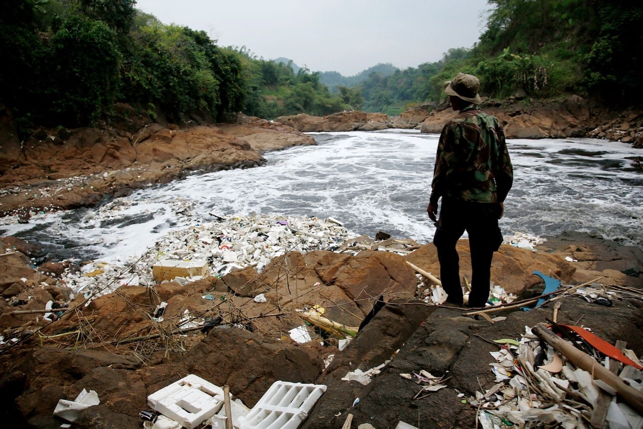 A farmer who grows bananas along the banks of the heavily polluted Citarum river looks over an area of the river near his farm in Cipatek, Indonesia, 8 November 2013, Ed Wray/Getty Images