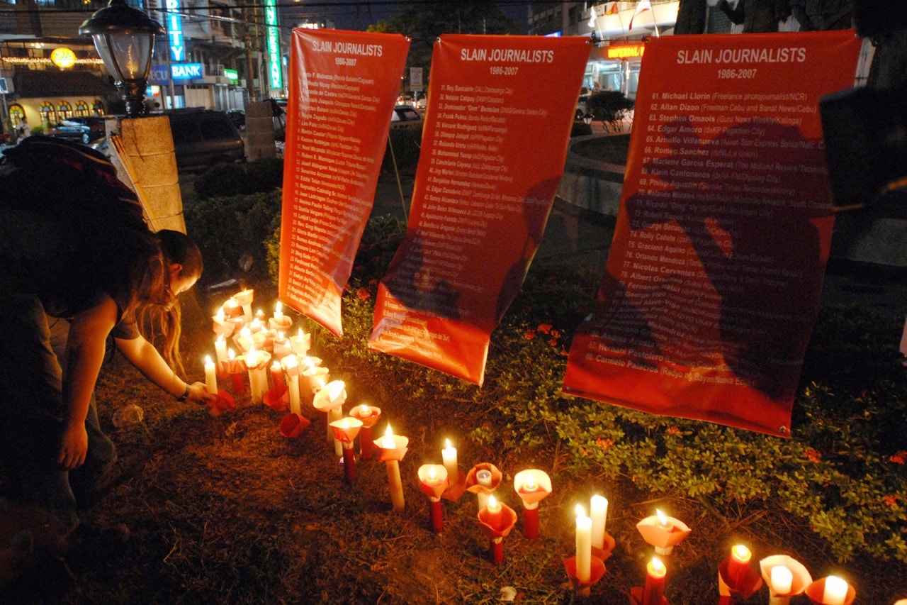 A demonstrator lights candles in honour of slain journalists on World Press Freedom Day, Manila, Philippines, 3 May 2007, ROMEO GACAD/AFP/Getty Images