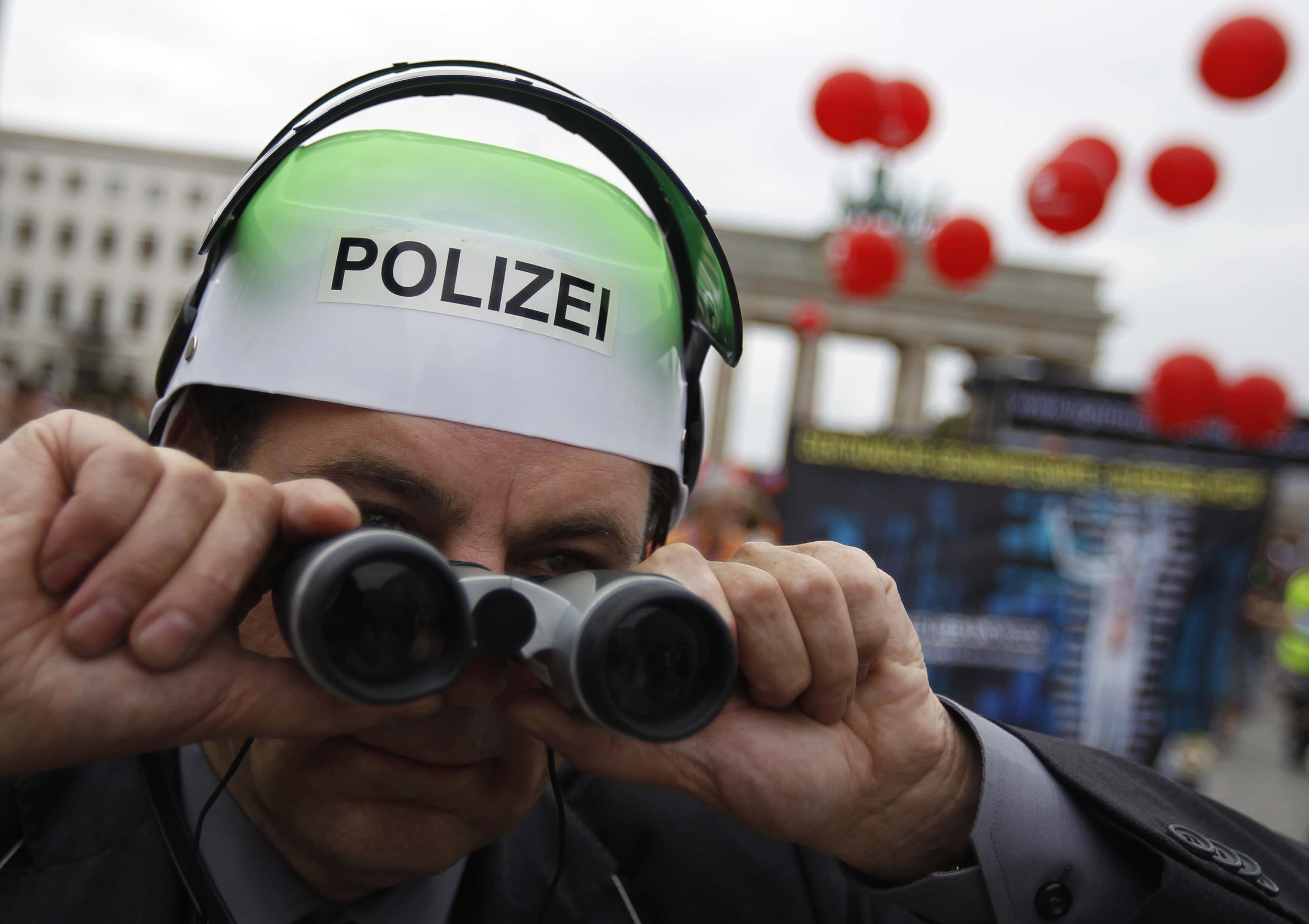 A man wears a fake police helmet during a "Freedom instead of Fear" protest calling for the protection of digital data privacy in Berlin, 10 September 2011 , REUTERS/Thomas Peter