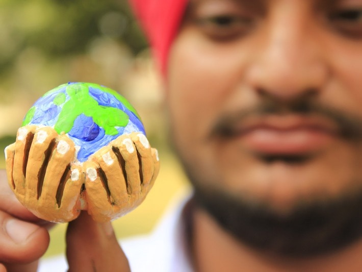 Artist Amritpal Singh shows off his miniature design created for Earth Day, April 2013, Demotix/Reporter#41763