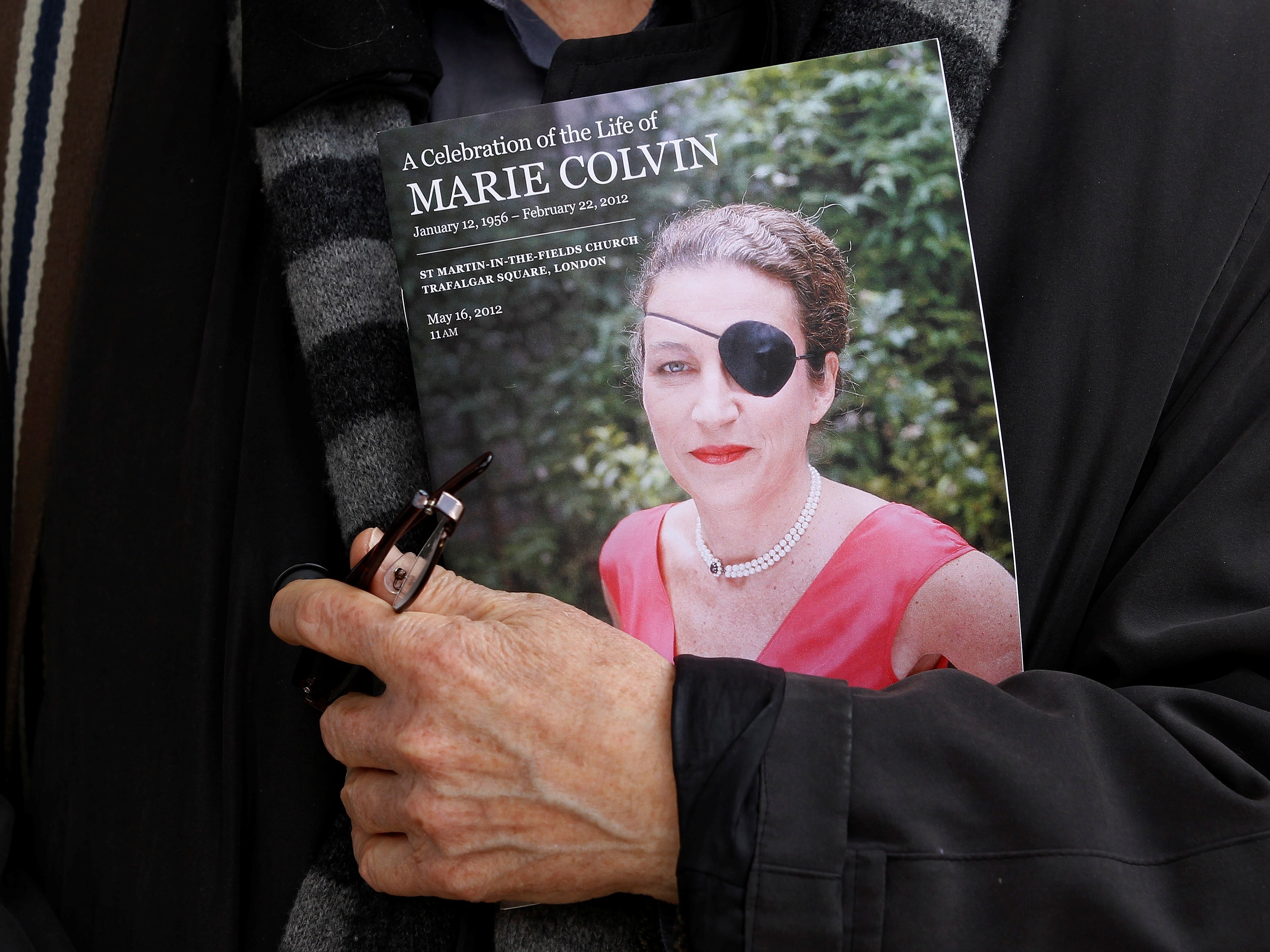 A man holds a sign honoring "Sunday Times" journalist Marie Colvin after a memorial service, 16 May 2012; Colvin has been posthumously named a World Press Freedom Hero, REUTERS/Stefan Wermuth