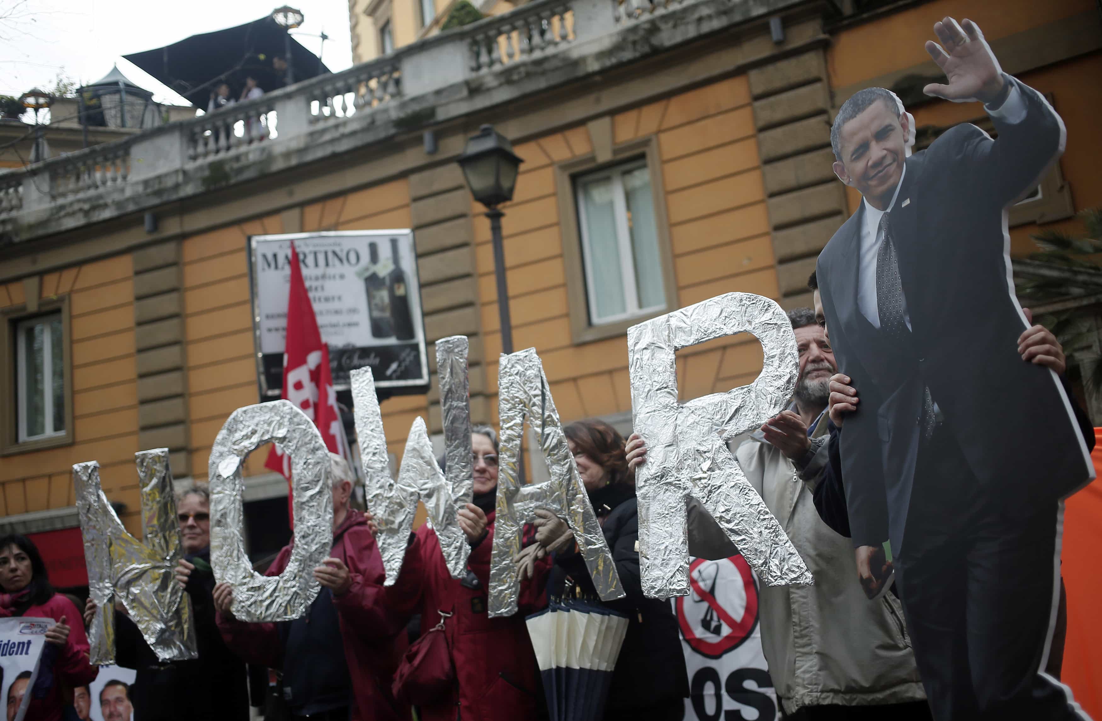 After Barack Obama urged NATO allies to up their defense budgets, demonstrators protest near the U.S. Embassy in Rome, 27 March 2014, REUTERS/Yara Nard