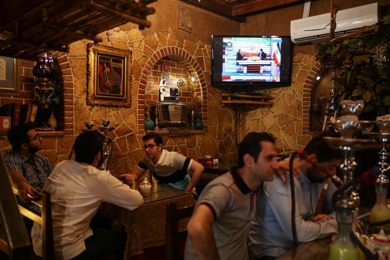 Iranians sit in a coffee shop as a TV screen broadcasts election results, in Tehran, Iran, 20 May 2017, TIMA via REUTERS