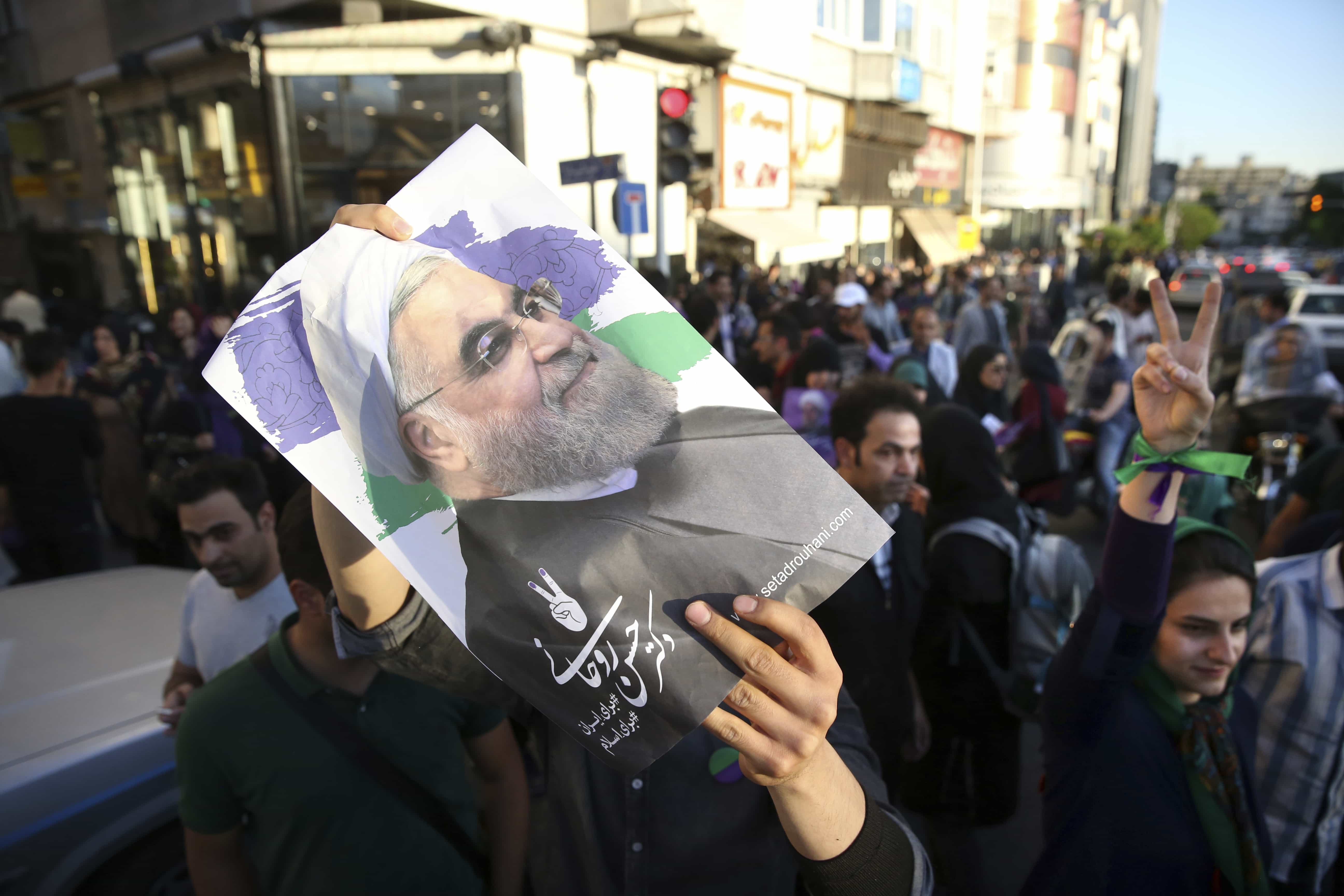 A supporter of Iranian President Hassan Rouhani in the presidential election takes part in a campaign rally in Tehran, 9 May 2017, AP Photo/Vahid Salemi